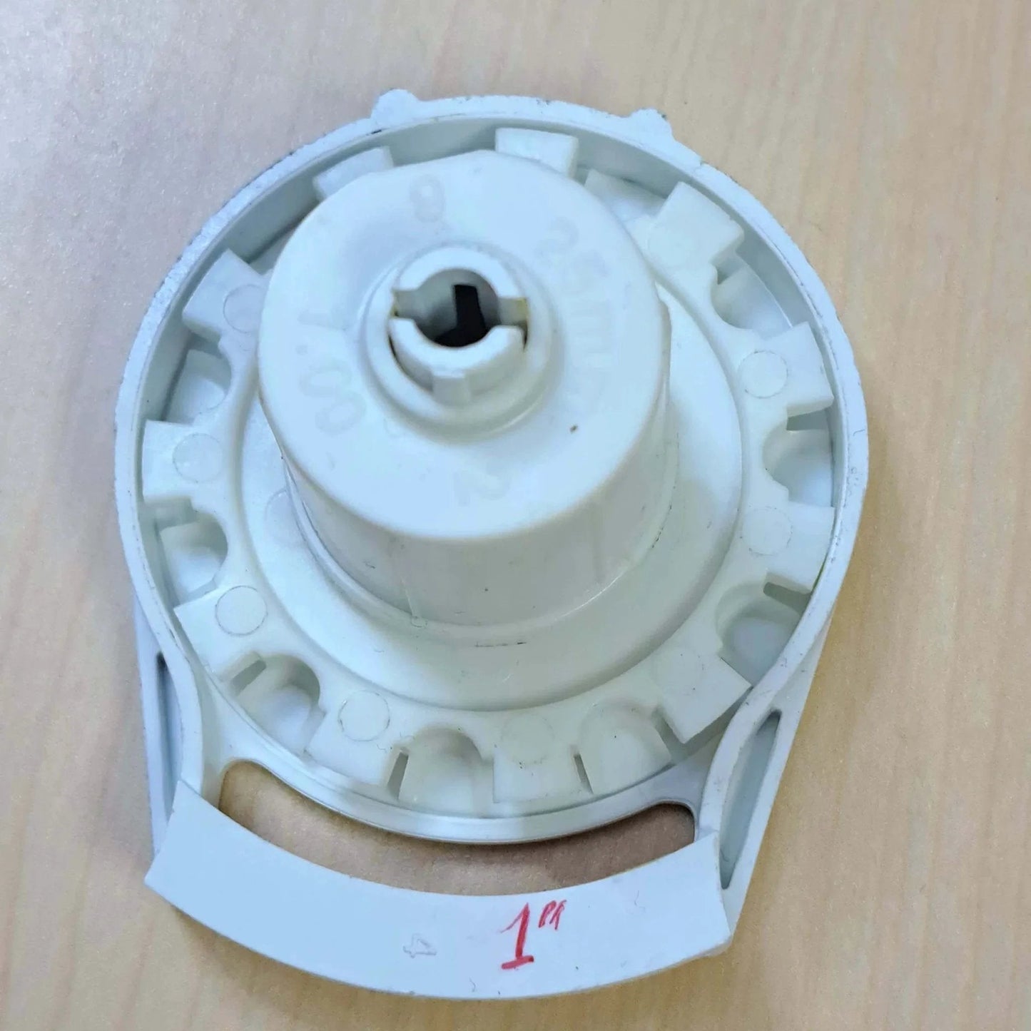 Close-up of Clutch R Series with Bead Stopper (White, R8-1" Tube) showing the gear mechanism on a wooden surface.