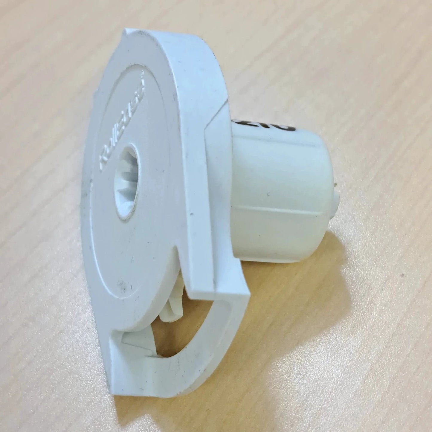 Side view close-up of Clutch R Series with Bead Stopper (White, R8-1" Tube) showing white plastic construction on wood surface.