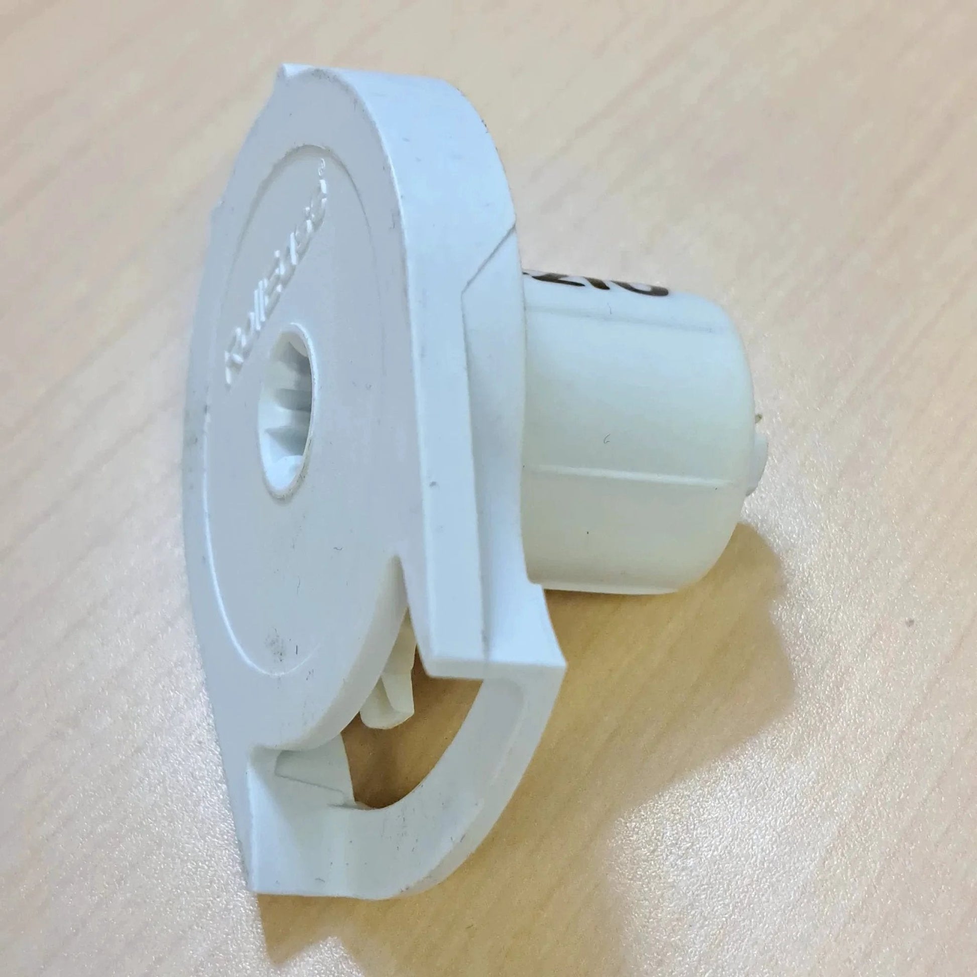 Side view close-up of Clutch R Series with Bead Stopper (White, R8-1" Tube) showing white plastic construction on wood surface.