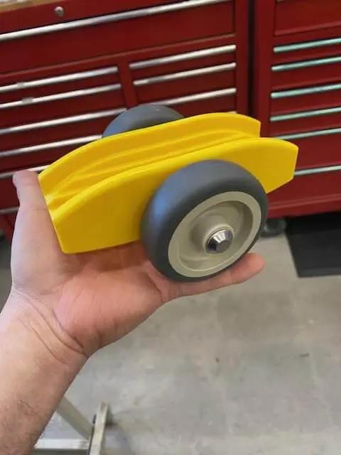 Compact Plywood And Drywall Dolly For Moving Panels And Drywall Carts By Plywheels Portable Panel Carrier Rolls Any Material That Fits In The Slots Great For Onsite Construction Jobs Lightweight Handy Tool For Quick Roll And Load, held in hand in workshop