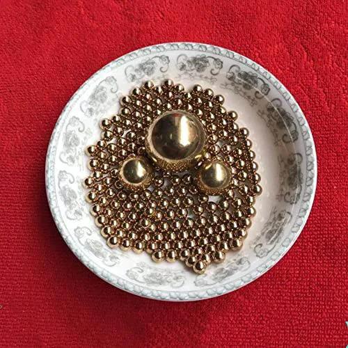 Ceramic bowl with 1mm 500pcs Solid Pure Copper Balls - Brass Ball Bead on red fabric background