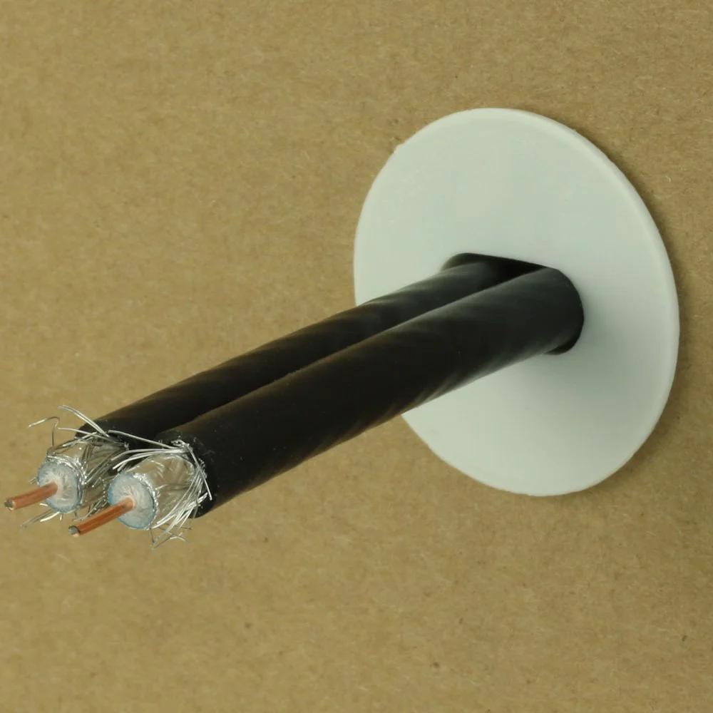 Dual Feed Through Cable Bushings White 100 Pack For Low Voltage Wall Openings seals two black cables through a wall.