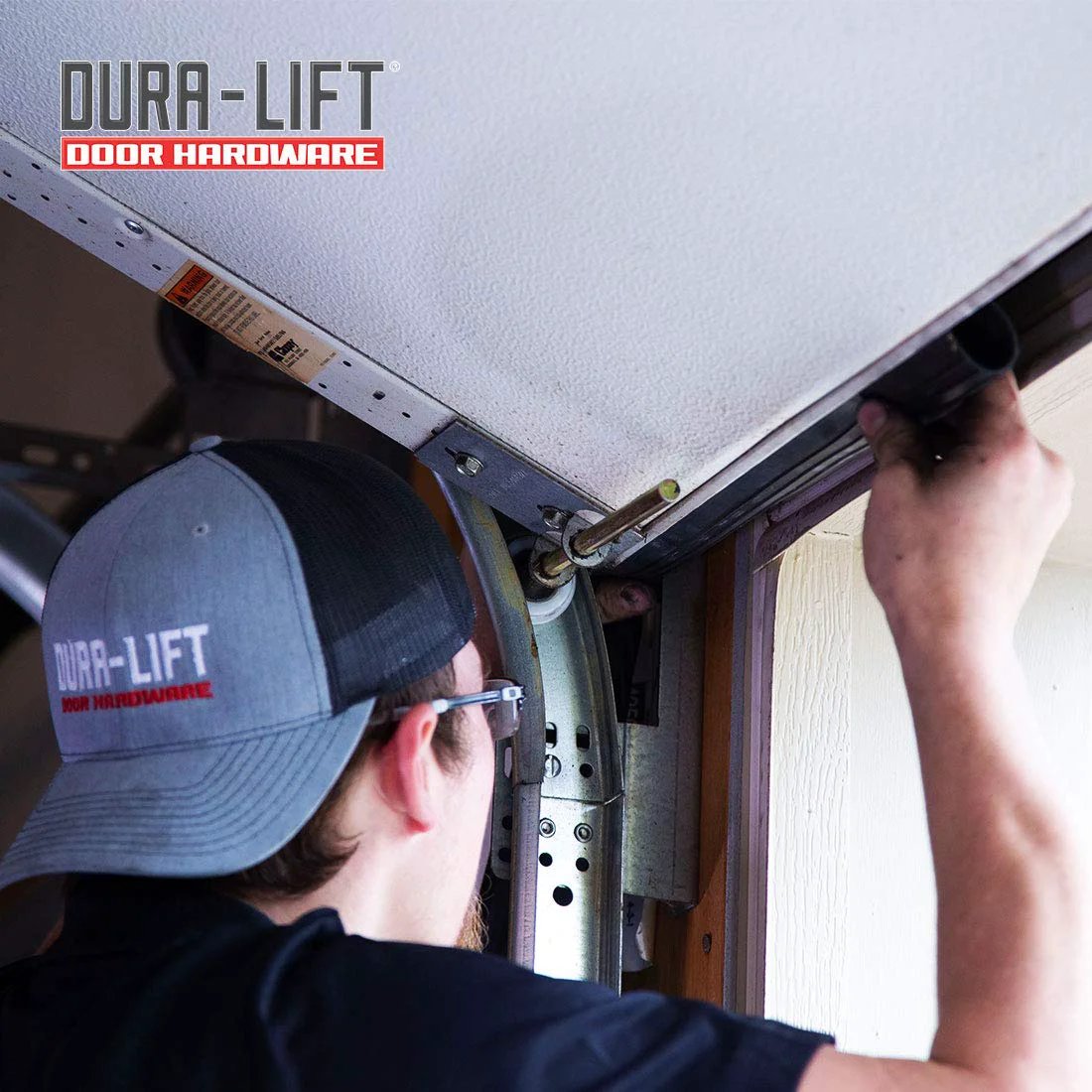 Person installing Premium EPDM Rubber Weather Seal For 8 Foot Wide Garage Doors Double Black on a garage door track.