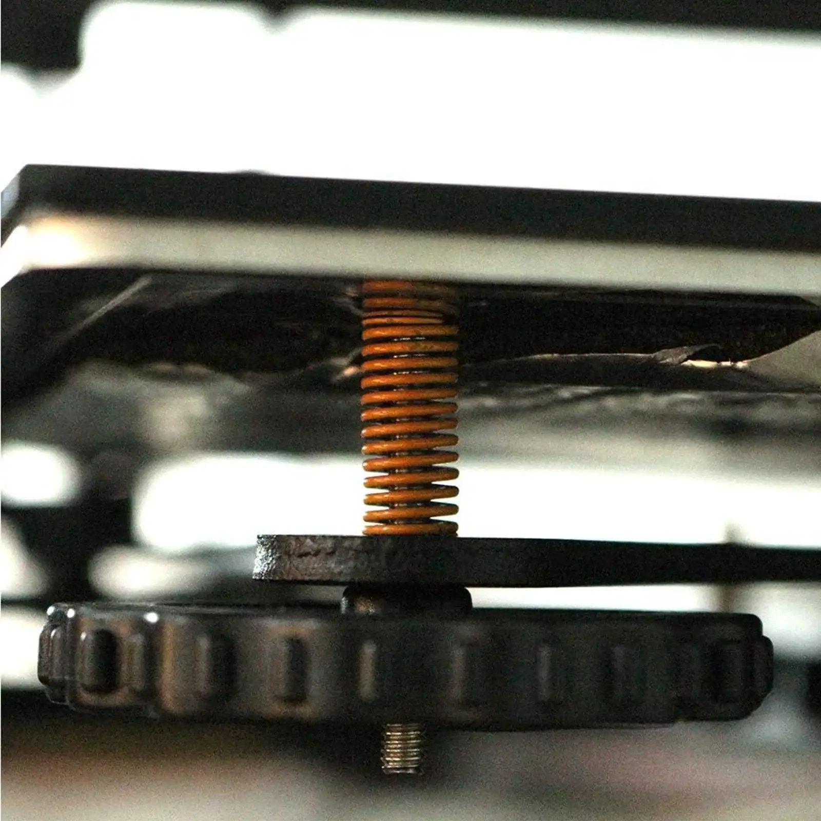 Side view of a yellow Light Load 8mm OD 20mm Long Die Spring Mold for Ender 3 bed 3D printer, showcasing installation.