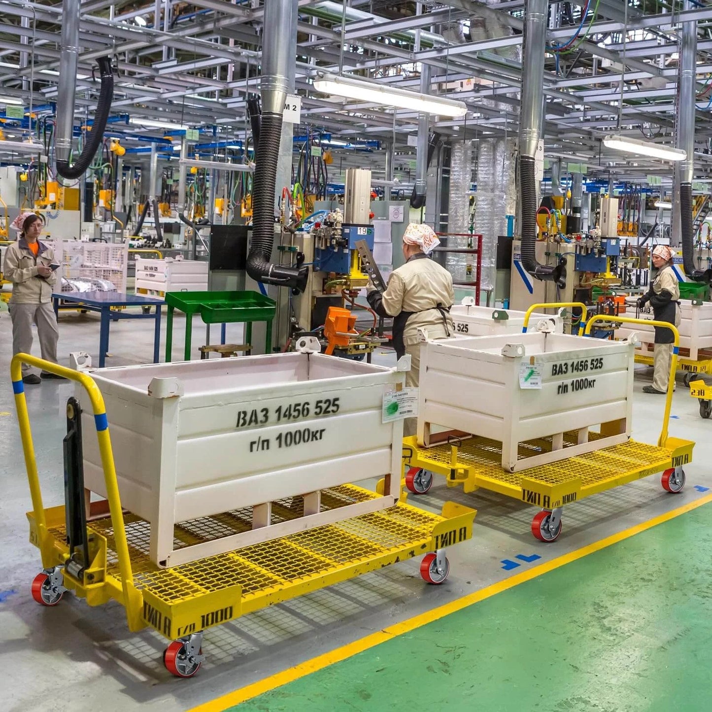 Factory workers using platform trucks with 5"x2" Industrial Casters- Heavy Duty casters, Polyurethane Casters Wheel for smooth motion.
