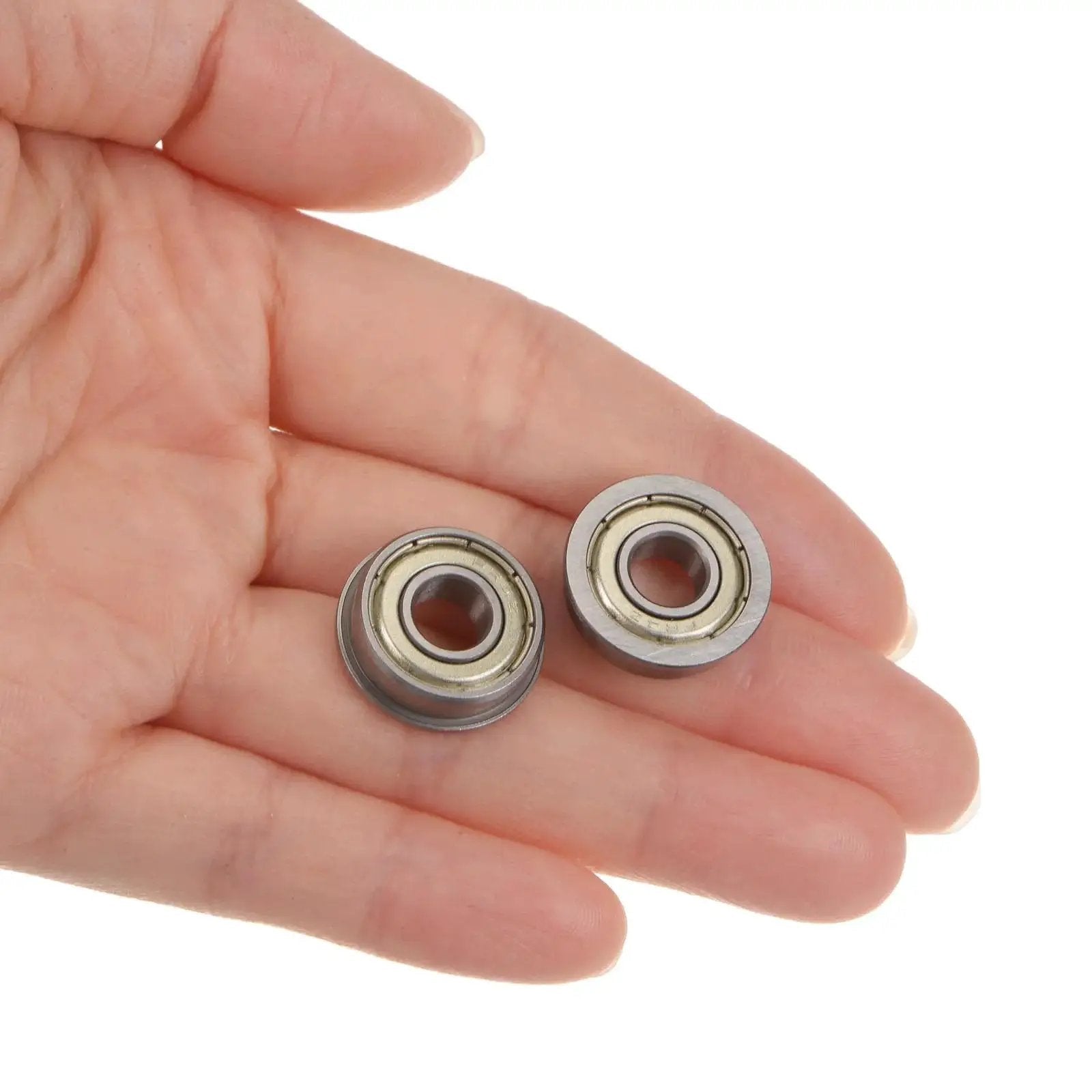 Hand holding Flanged Ball Bearing 1 Quarter By 5 Eighth By 0.196 Inch Double Shielded Chrome Steel FR4ZZ 4 Pack