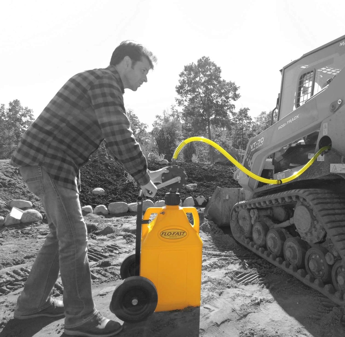 Man using FLO-FAST Pro Pump, 8GPM, Telescoping Draw Tube, fits Containers and Barrels, Portable, Durable, Made in USA for ATV fueling