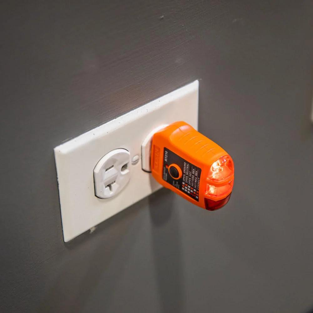 GFCI receptacle tester plugged into wall socket from Infrared Thermometer and GFCI Receptacle Tester Kit