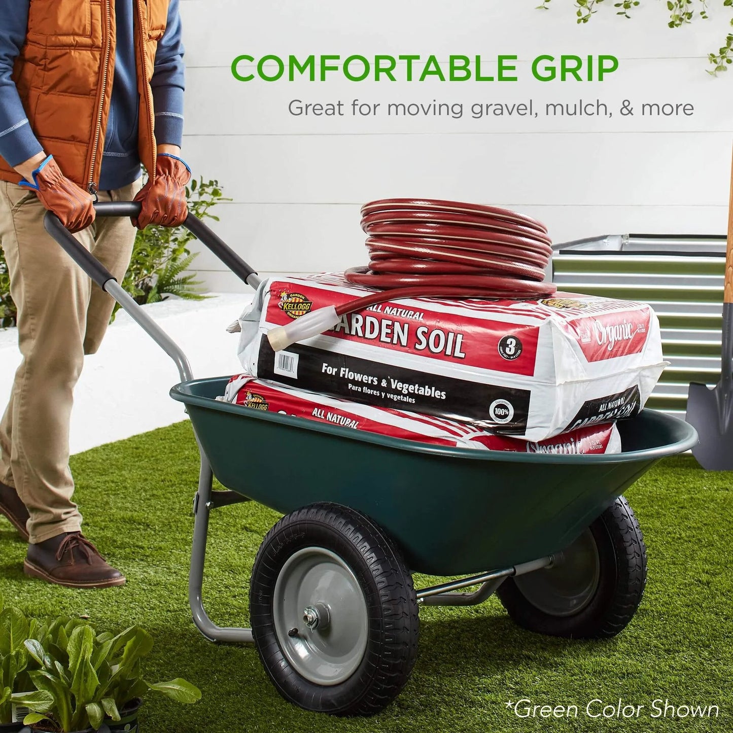 Person using Dual Wheel Home Utility Yard Wheelbarrow Garden Cart with Built In Stand 5 Cubic Foot Capacity 330 lb Load Red for Lawn Gardening Landscaping and Construction to move garden soil bags.