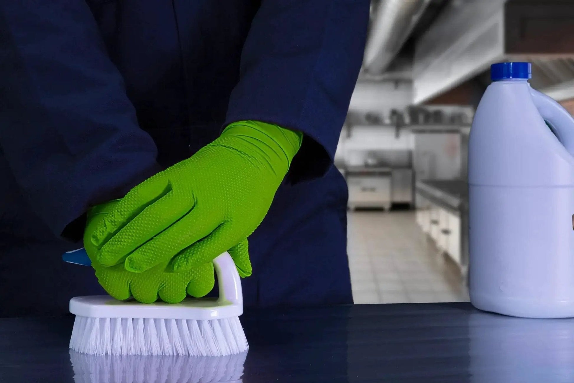 Person wearing Green Nitrile Latex Free Gloves 8 Mil Heavy Duty Raised Diamond Texture Box 100 cleaning with brush in kitchen
