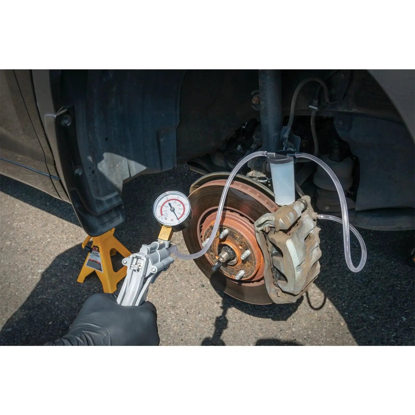 One Man Hand Vacuum Pump Kit For Brake Bleeding And Automotive Tests By Performance Tool in use on car brakes