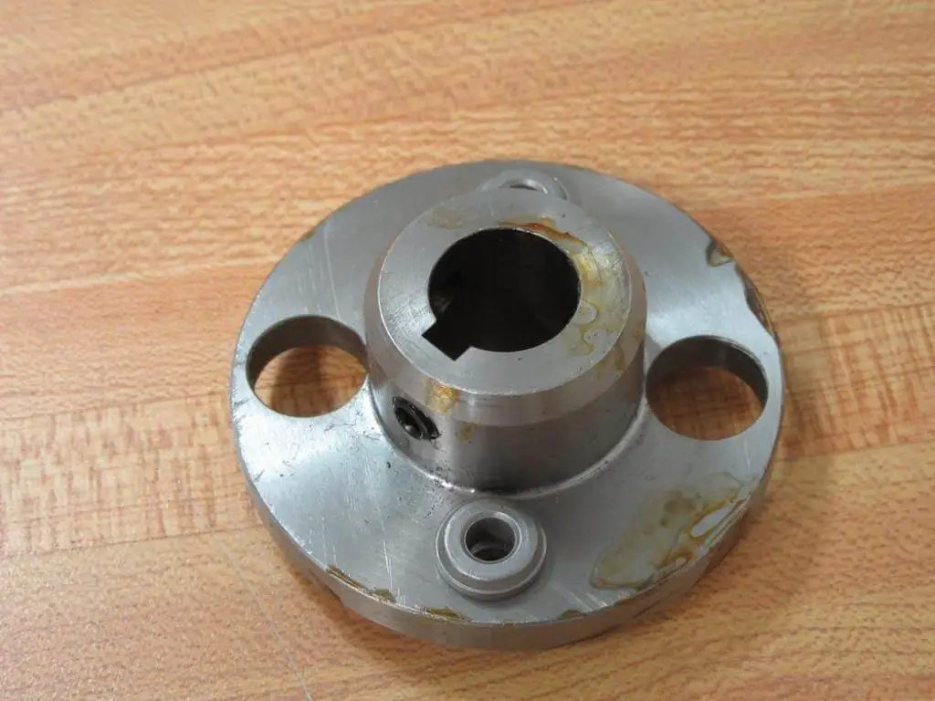 Heavy Duty Hub For Shafts And Conveyors Built To Last With Two And A Half Inch Outer Diameter Five Eighth Inch Bore One Inch Width Ideal For Industrial Power Transmission And Pulleys Model 814412 Rexnord showing front view on wooden surface.