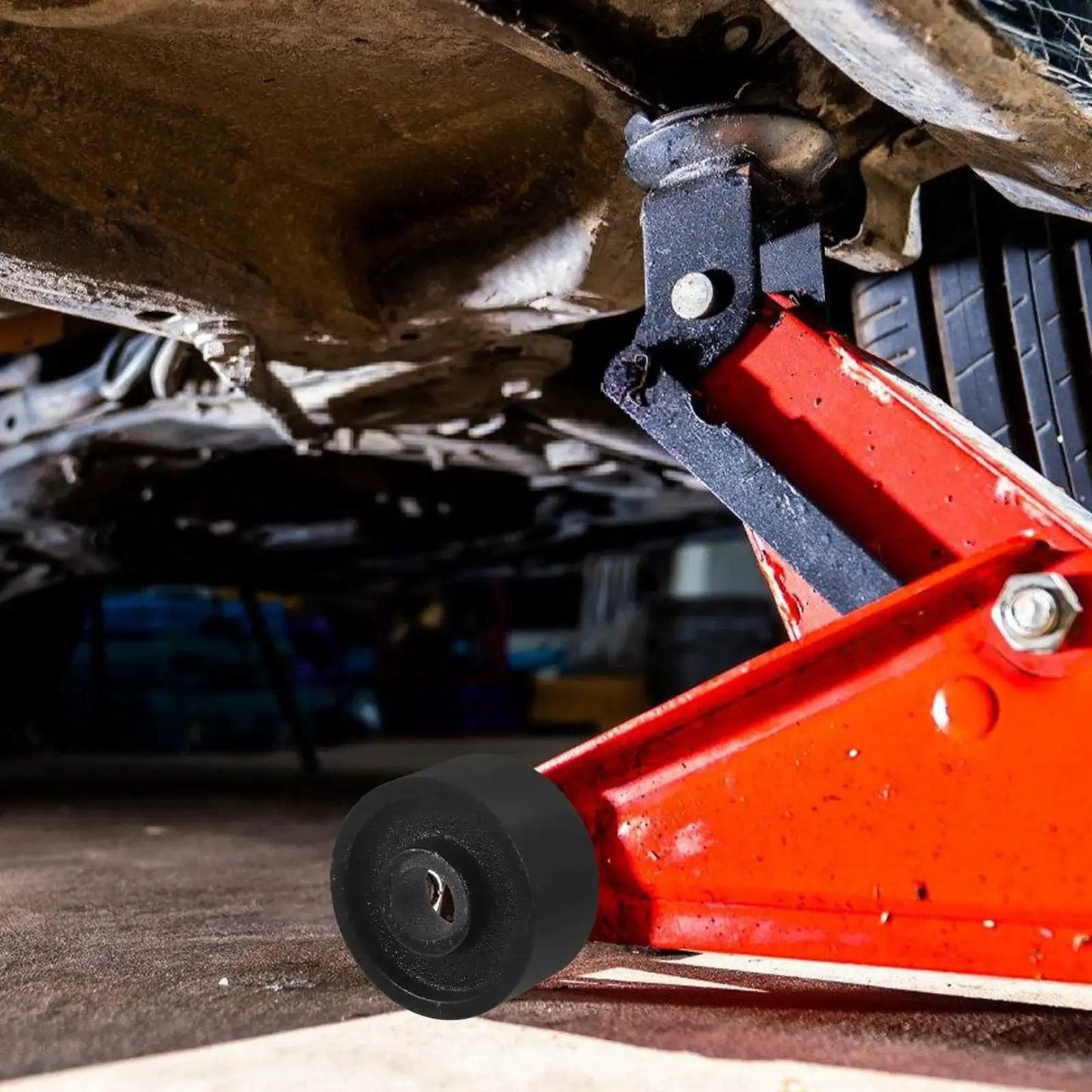 Universal Steel Front Wheel Replacement For Hydraulic Floor Jacks 2.5 Ton To 3.5 Ton installed on a red hydraulic jack lifting a car