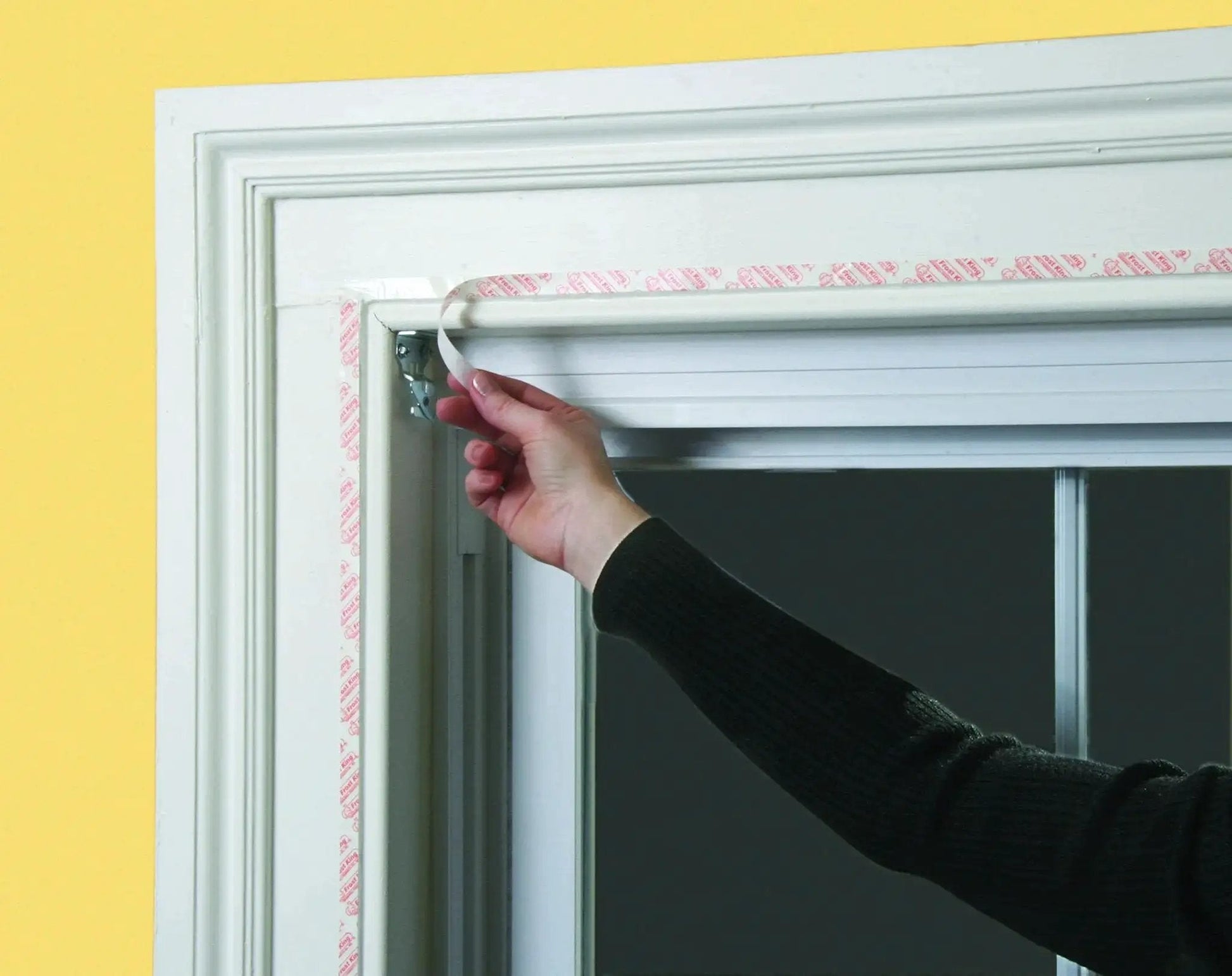 Installing Indoor Window Insulation Kit 4 Pack Shrink Film For Windows with included double sided tape on window frame
