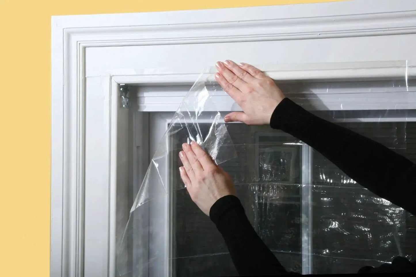 Applying Indoor Window Shrink Kit For 42 To 62 Inch Windows Clear 9 Pack Insulation Film to block drafts and boost efficiency