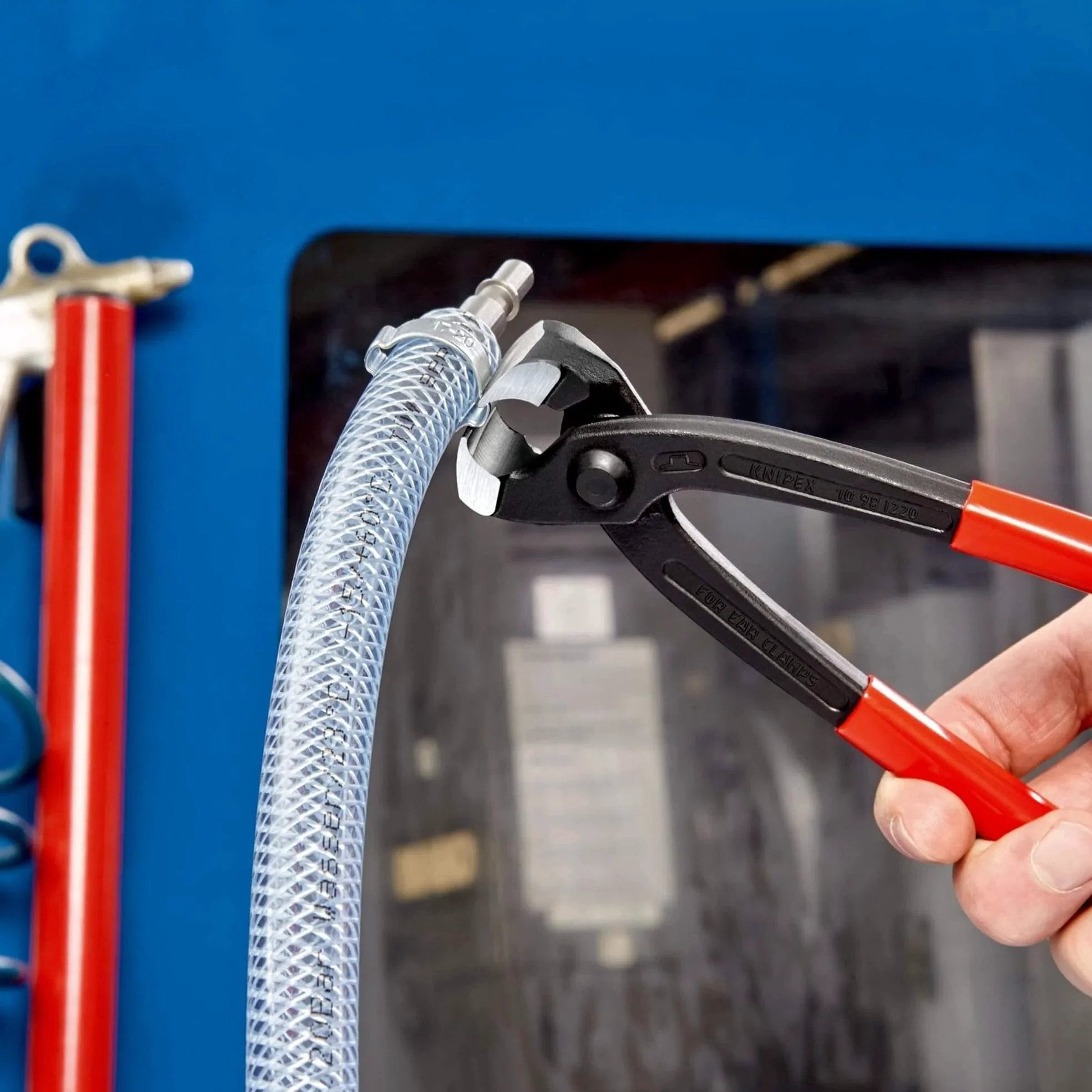 Knipex Tools Eight Point Seven Five Inch Ear Clamp Pliers 1 Ear 2 Ear Clamp Tool 1098i220 in use on a hose clamp