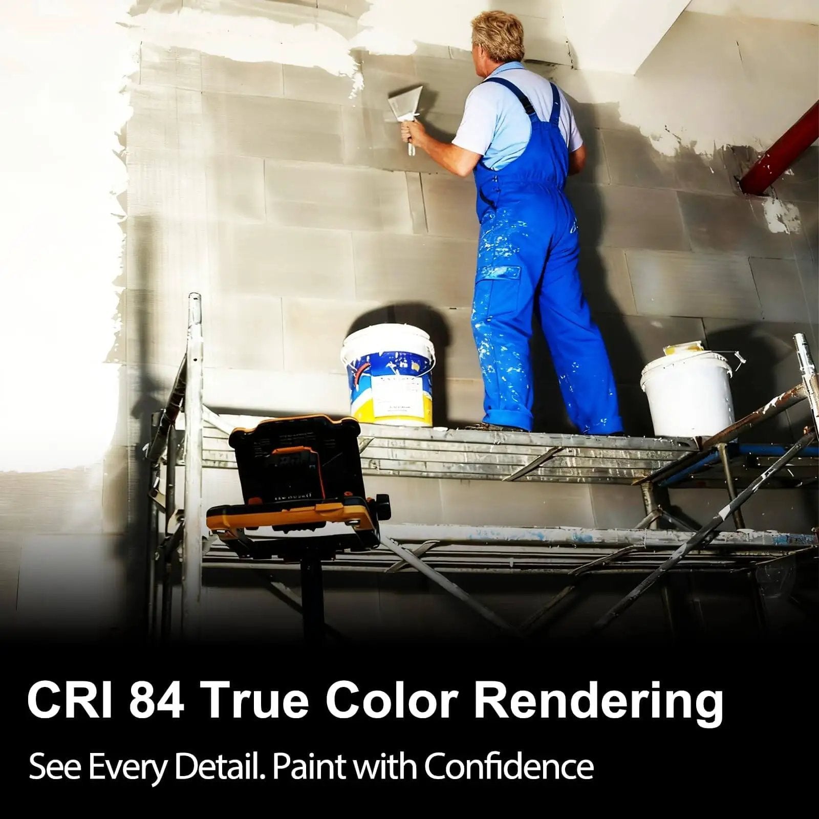 Person in blue overalls painting wall on scaffolding with buckets nearby, showcasing CRI 84 true color rendering lighting