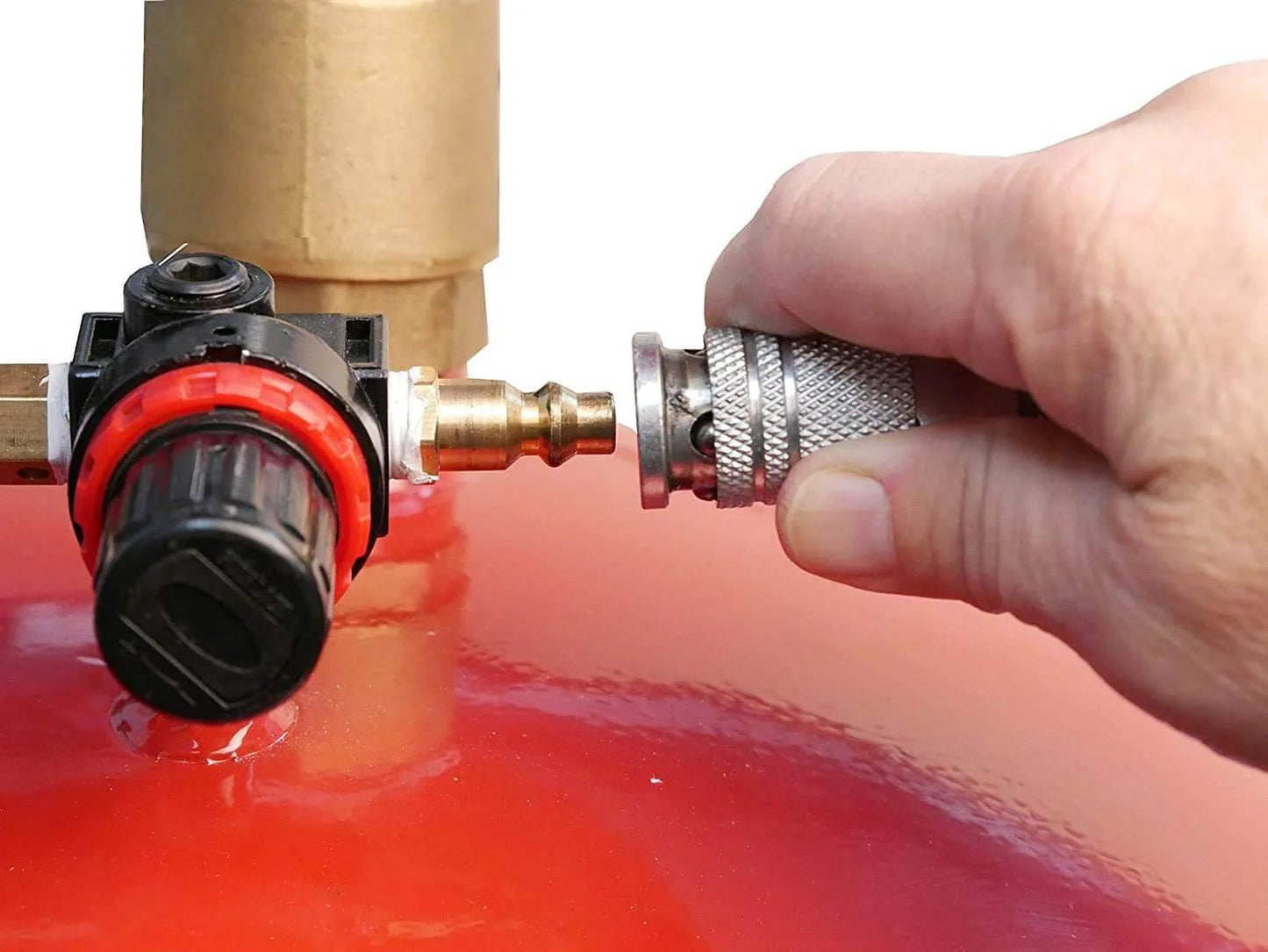 Hand attaching hose to Lincoln 3601 Pneumatic 18 Gallon Pressurized Fluid Drain and Evacuation Tank, red steel surface visible