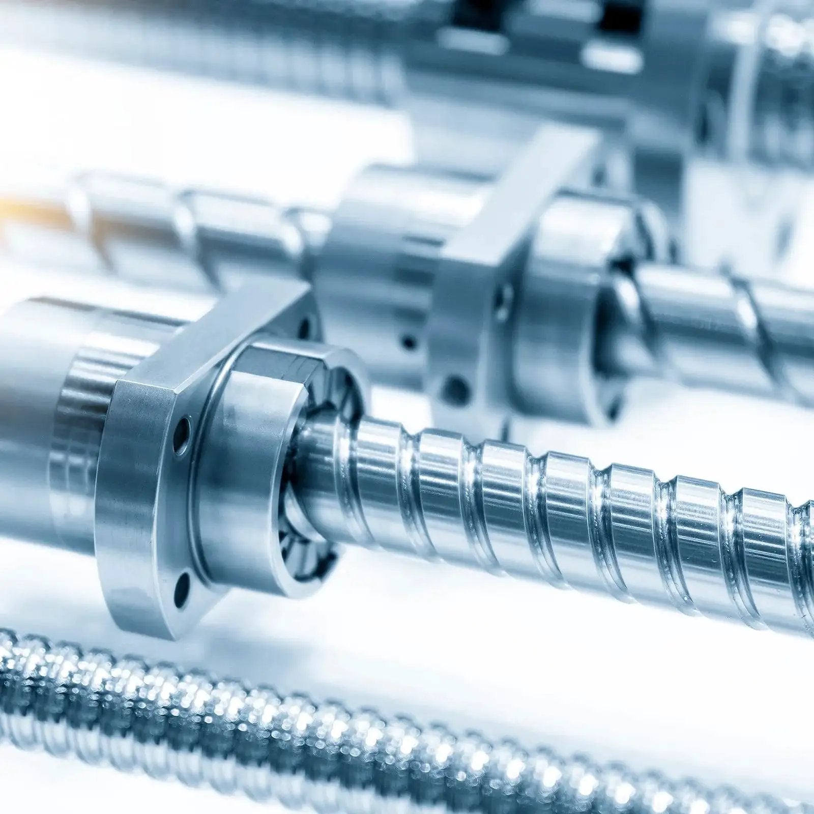 Close-up of industrial metal components, not clearly showing five piece sleeve bearings with one quarter inch bore and five sixteenth inch outer diameter.