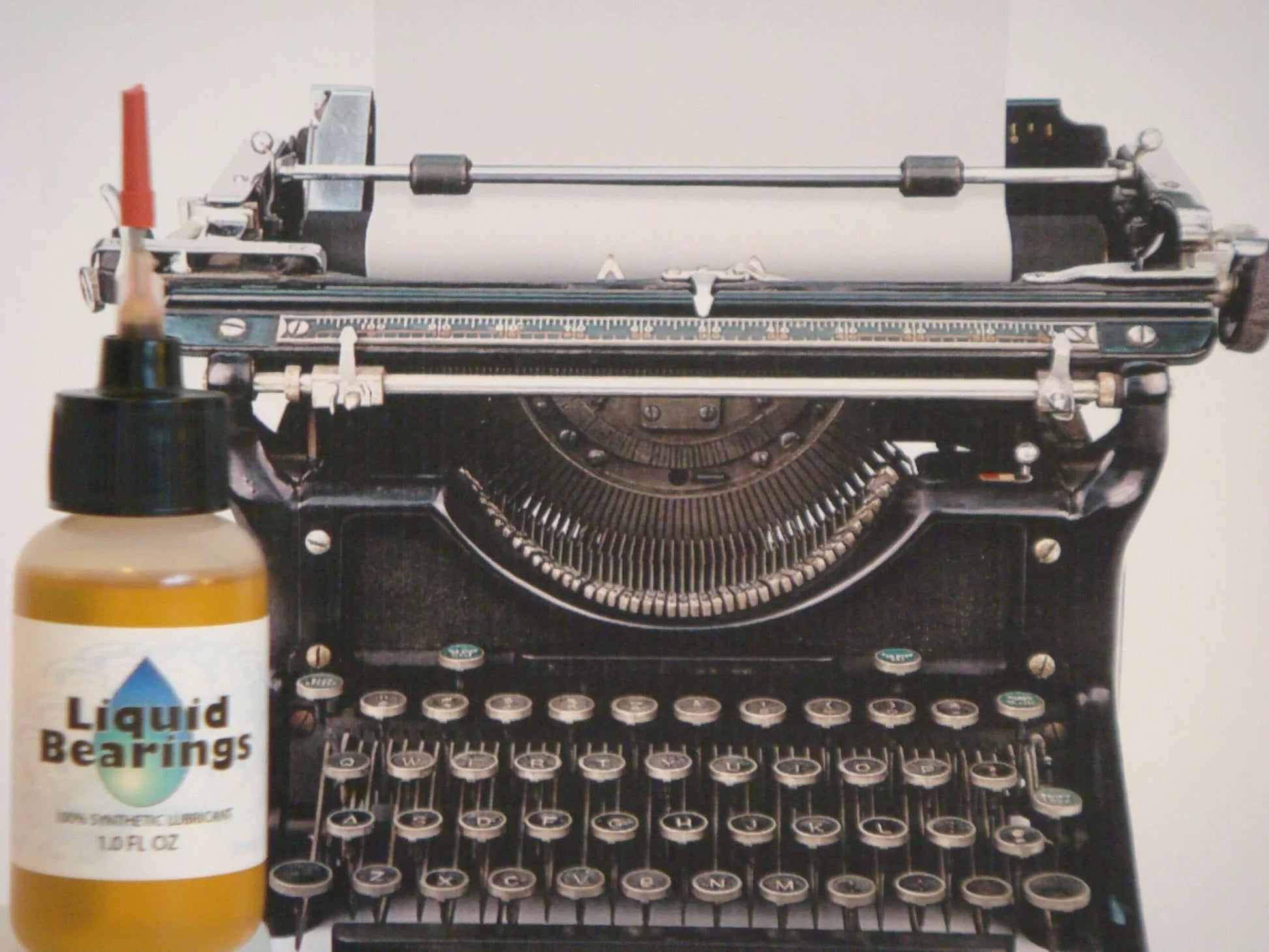Liquid Bearings, SUPERIOR 100%-synthetic oil bottle next to vintage typewriter