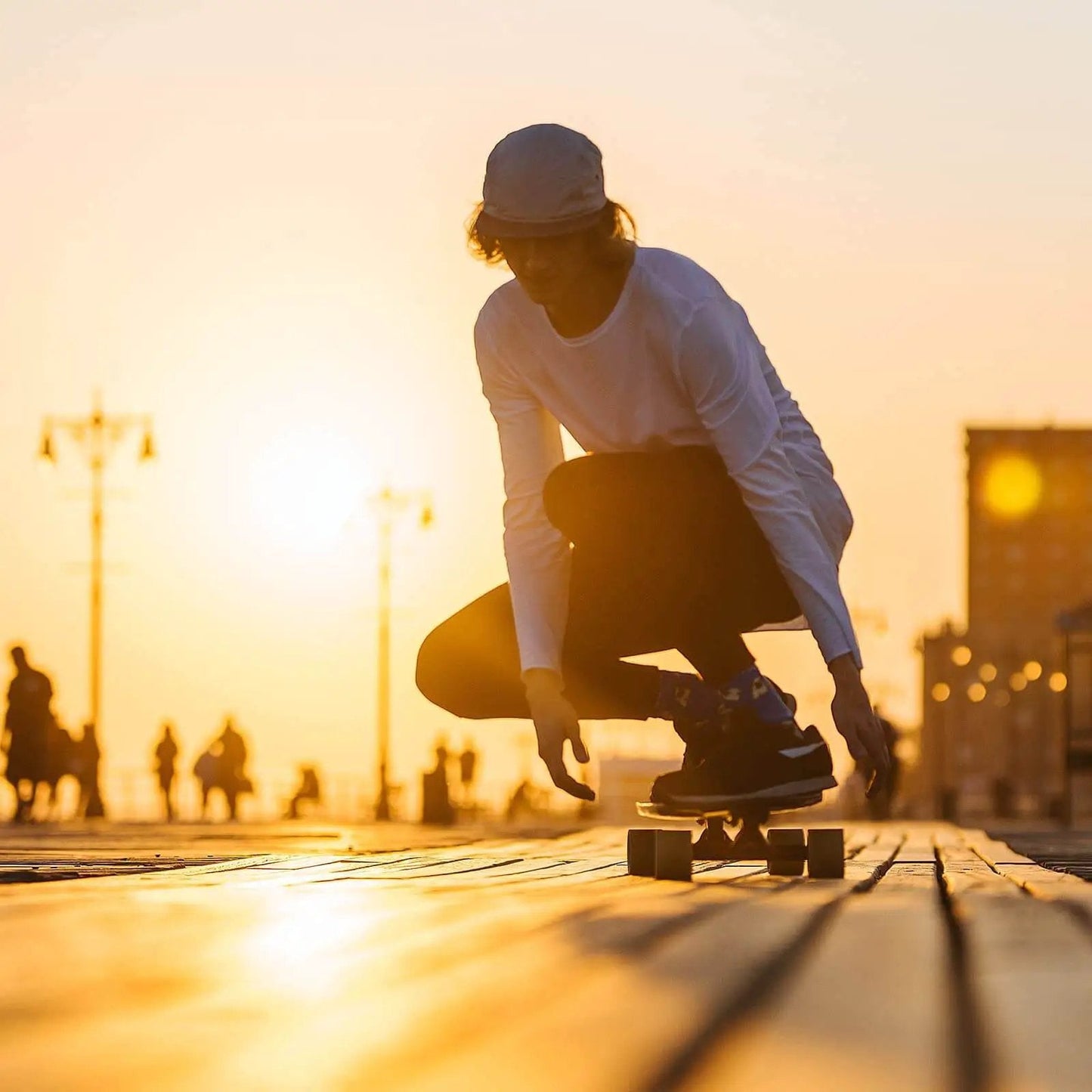 Person skating at sunset with 70mm 78A Longboard Wheels With Red ABEC 9 Bearings 4 Pack Street Cruiser Wheels On Wooden Path