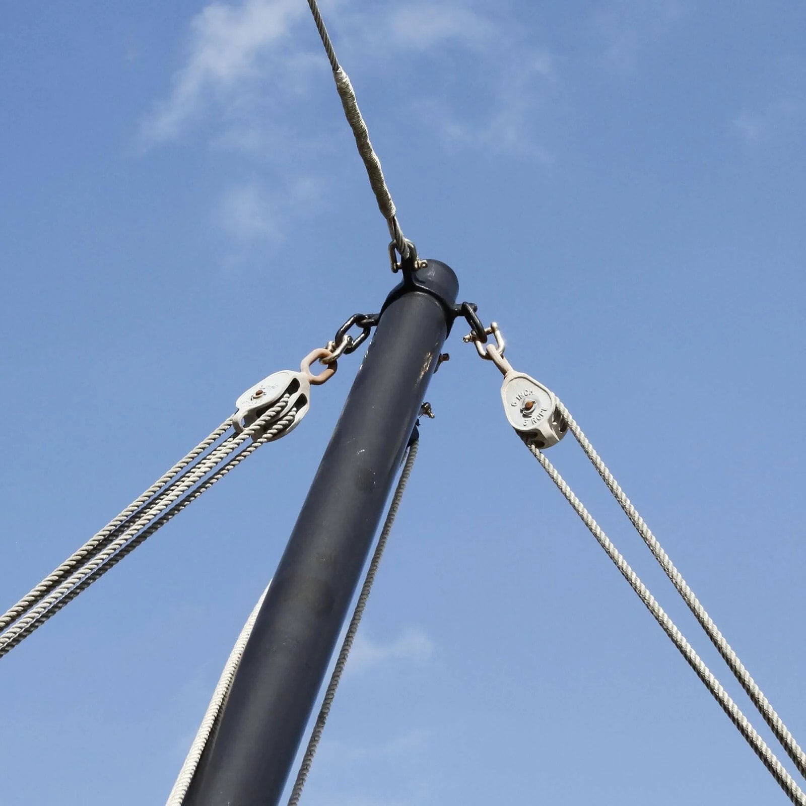 Stainless steel rigging with 6pcs M20 double pulley block and towing wheel attached to a pole against a blue sky