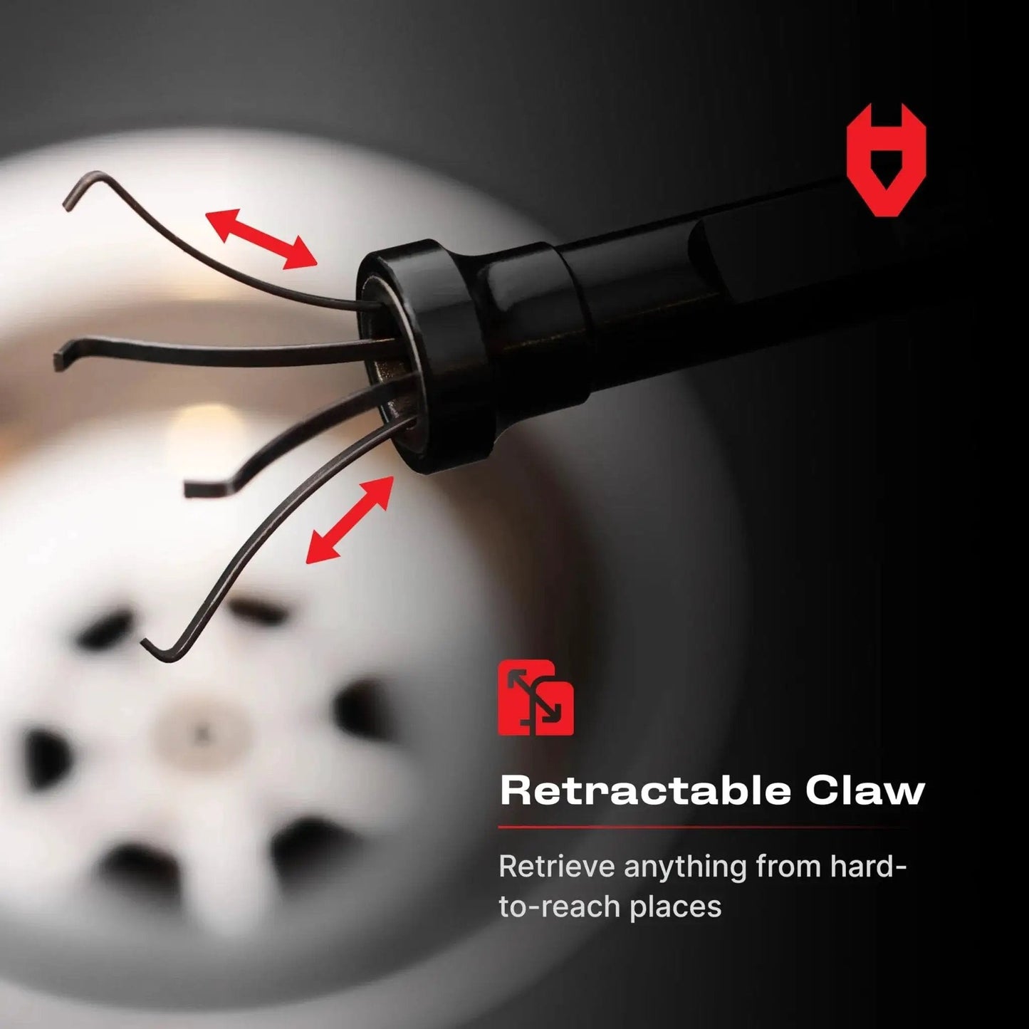 Close-up of flexible magnetic claw pickup tool with a bright LED light, showing 4-finger retractable claw above a drain.