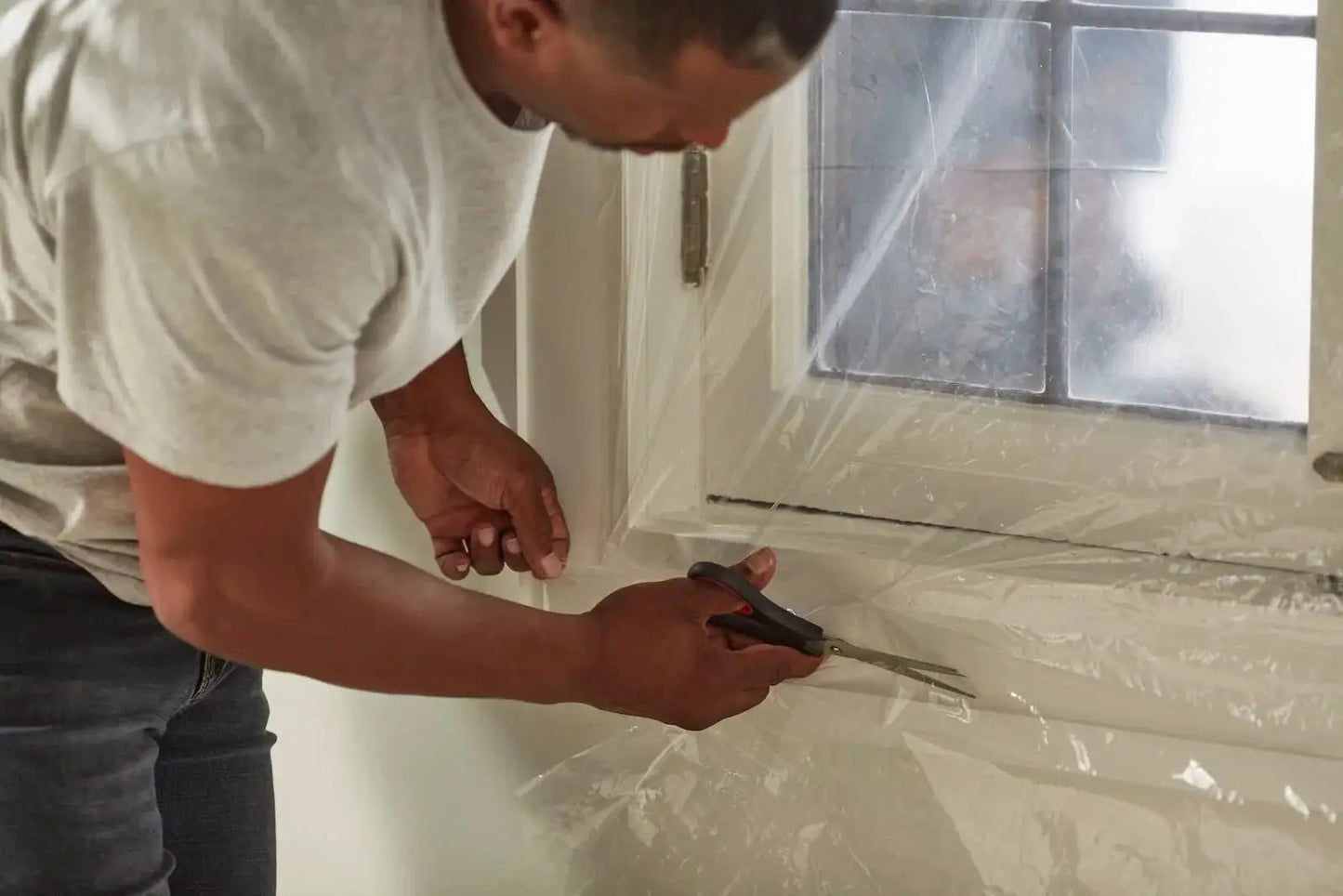Heavy Duty Window Insulation Kit For Cold Weather Fits Up To Five Windows With Puncture Resistant Shrink Film being installed indoors