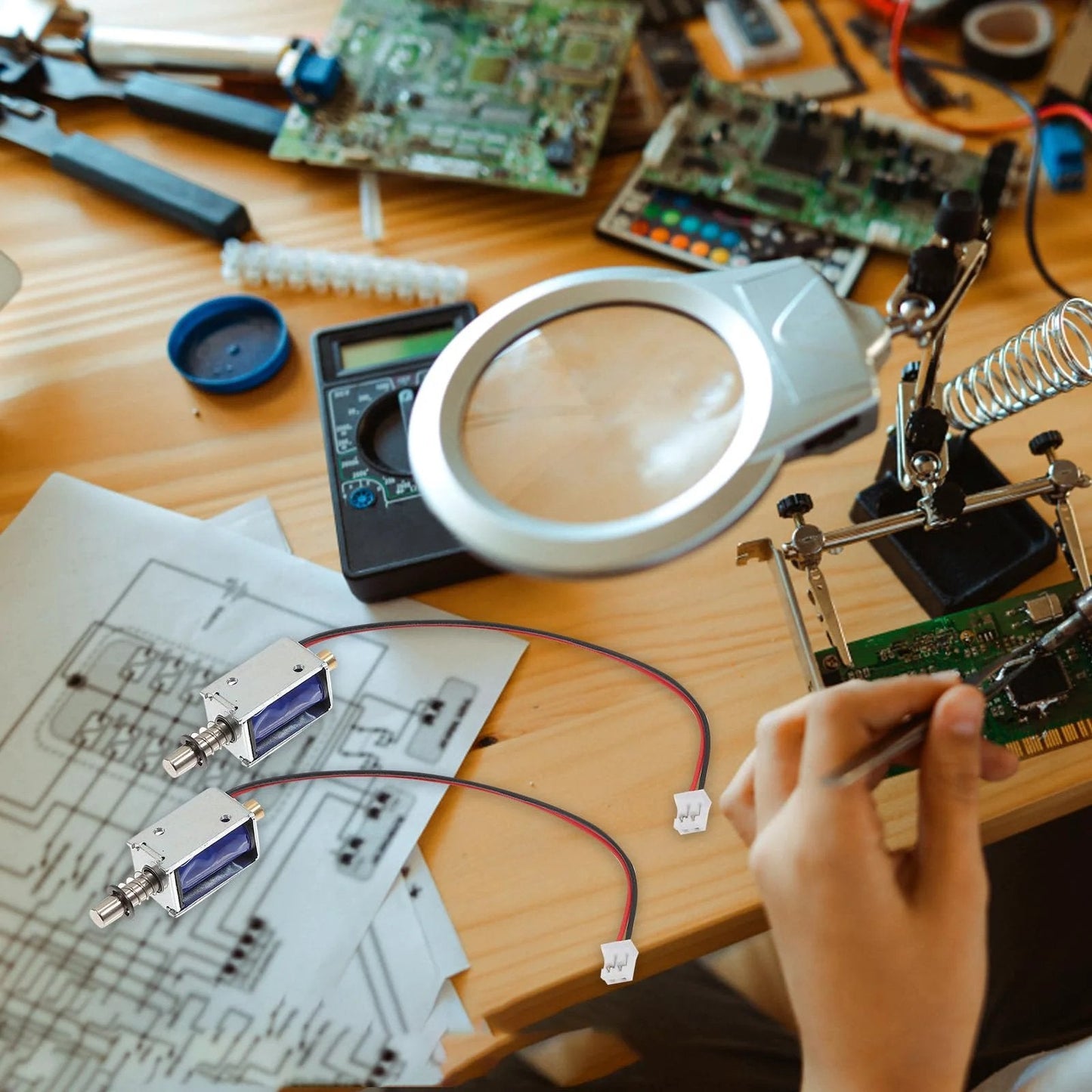 Mini Push Pull 12V Solenoid Electromagnet Open Frame Linear Actuator For Vending Machines And Industrial Projects With Plunger Spring Return on a workbench with electronics.