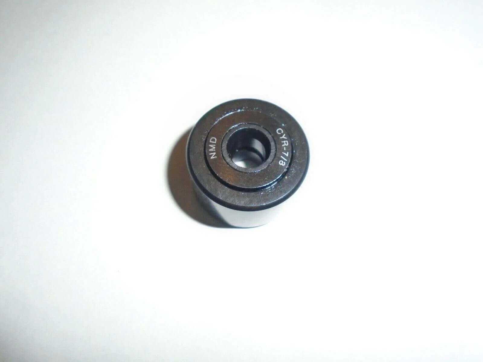 Top view of NMD CYR-7/8 Cam Follower Yoke Roller Bearing 1/4" ID X 7/8" OD X 9/16" Width BAB14 on white background.