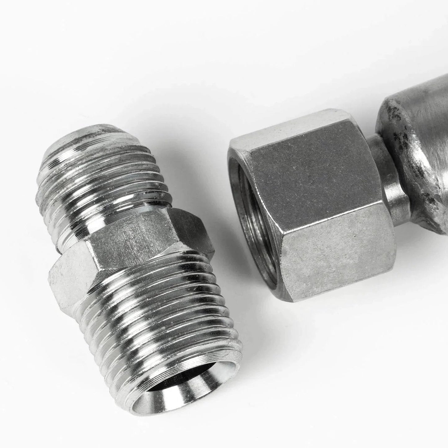 Half Inch By Thirty Six Inch Stainless Steel Flexible Compressed Air Hose With NPT Adapters featuring metal connector fittings close-up