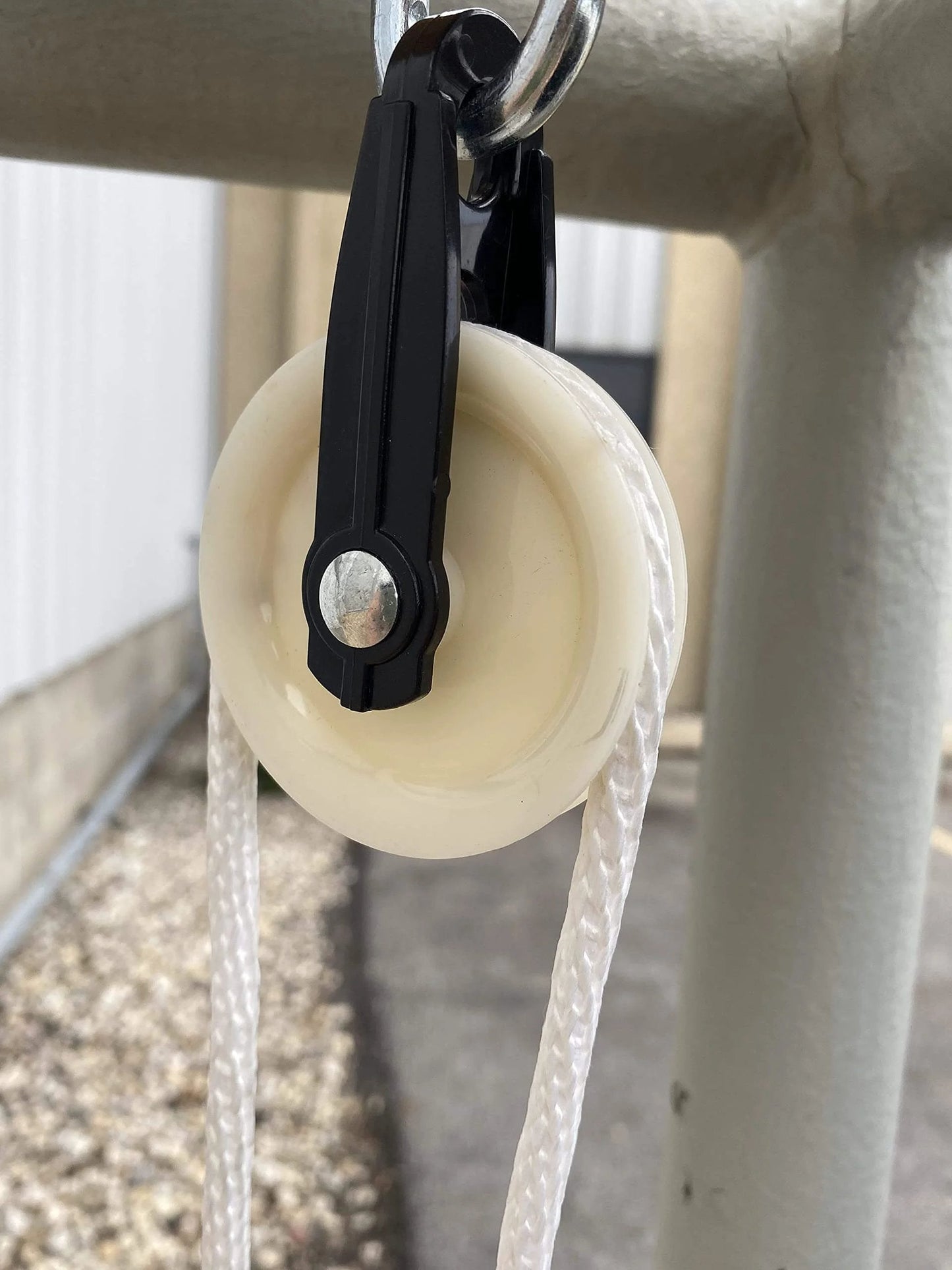 Installed 2-1/2-Inch Diameter Nylon Pulley - Durable, Smooth Outdoor Clothesline Pulley for 1/4-Inch Rope, close-up view