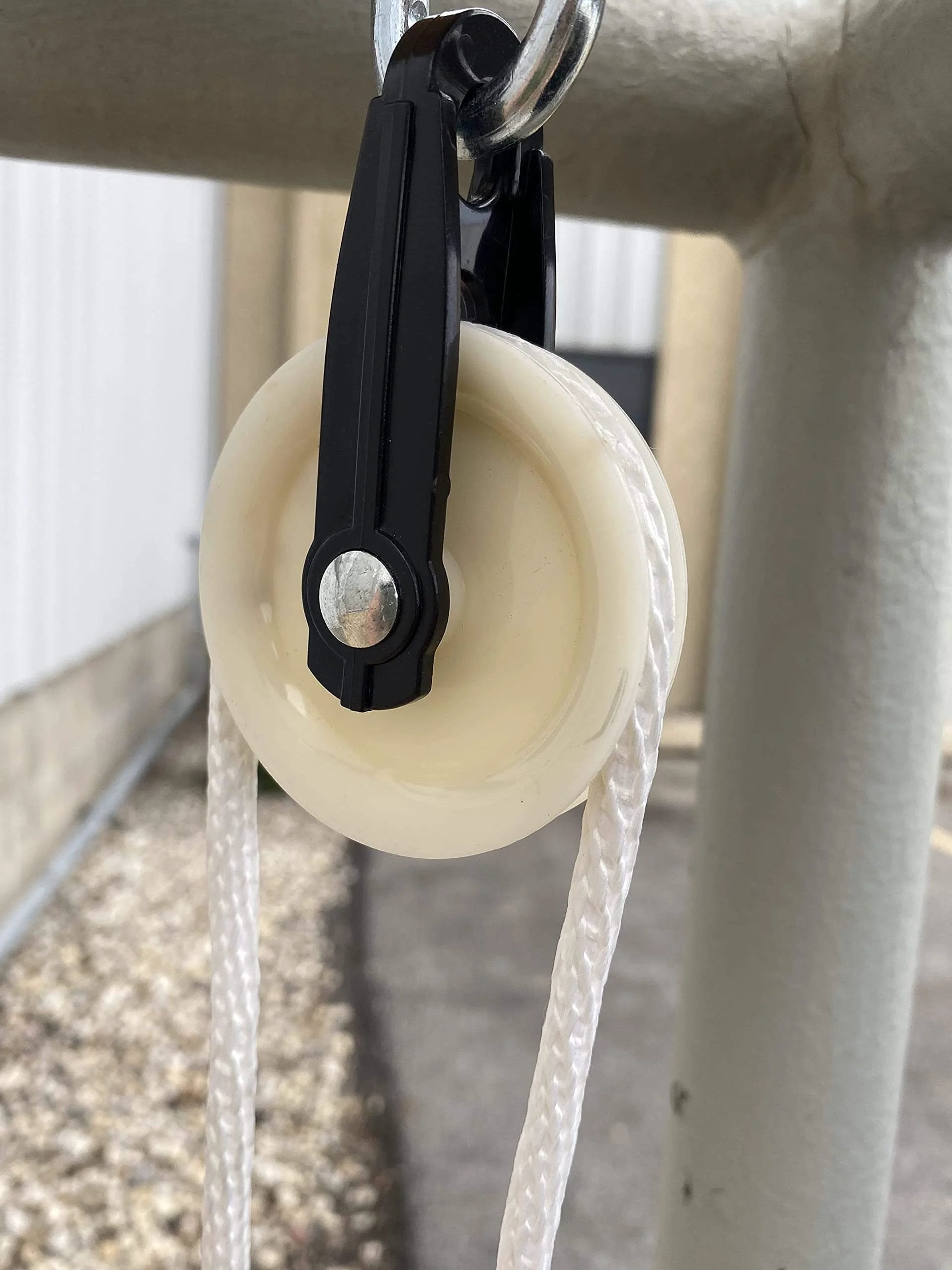 Installed 2-1/2-Inch Diameter Nylon Pulley - Durable, Smooth Outdoor Clothesline Pulley for 1/4-Inch Rope, close-up view