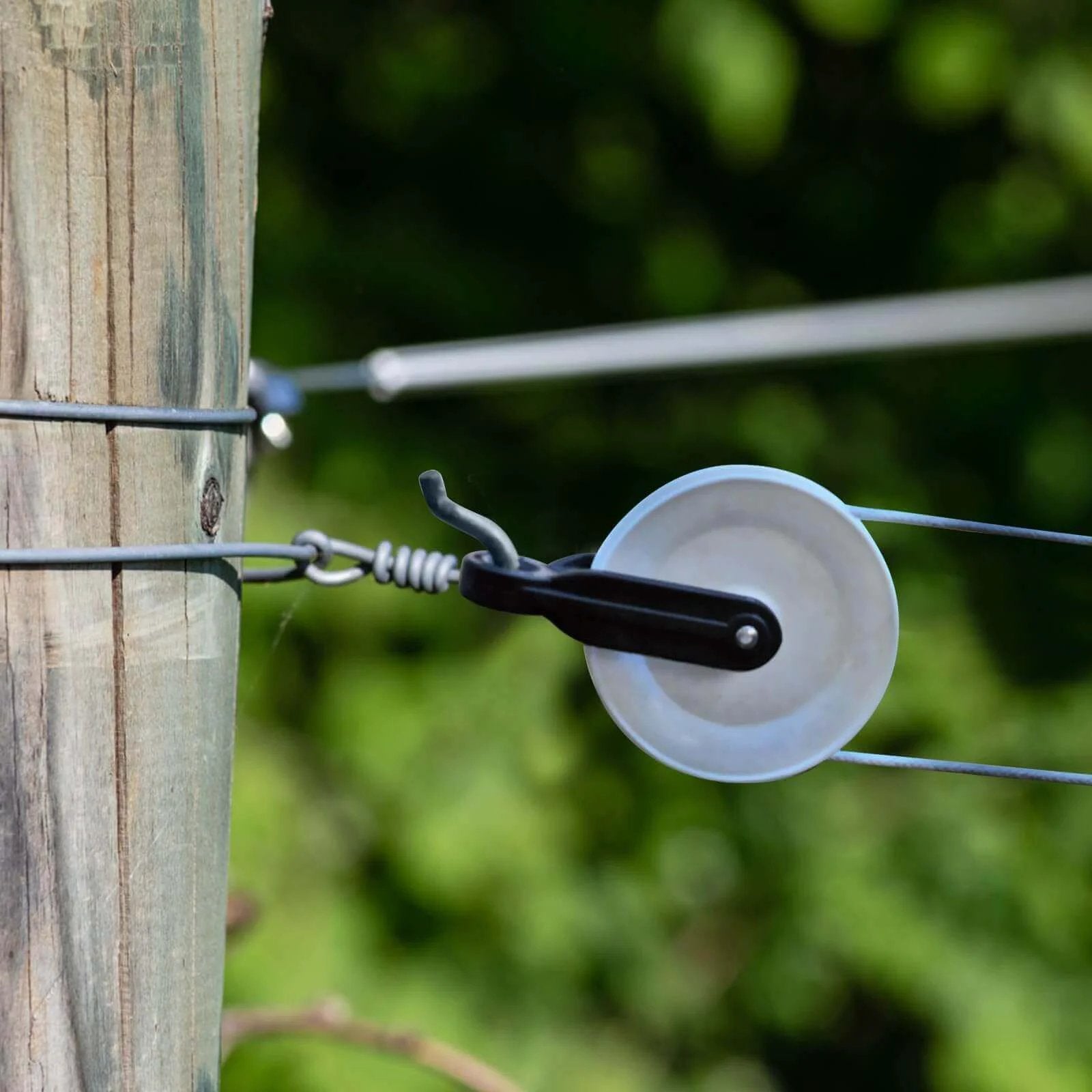 Installed 2 PCS Nylon Clothesline Pulley,2-1/2-inch Diameter Nylon Pulley on a wooden post for outdoor use