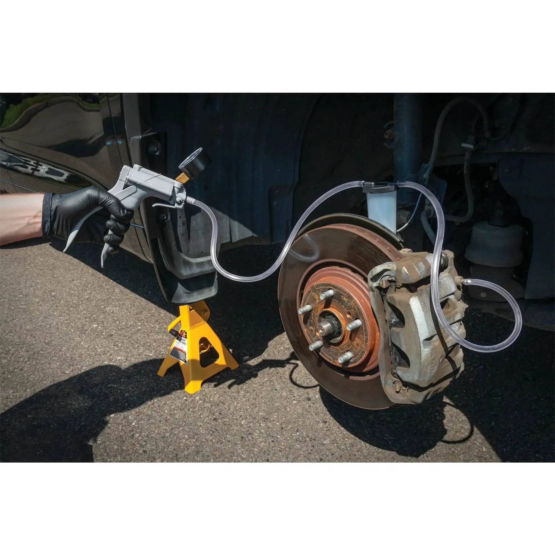 One Man Hand Vacuum Pump Kit For Brake Bleeding And Automotive Tests showing brake bleeding process on vehicle setup
