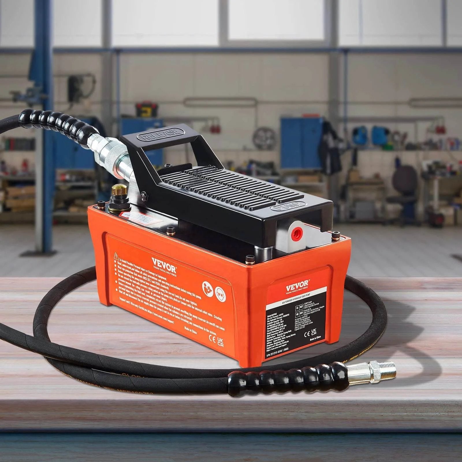 Air Hydraulic Pump, 10,000 PSI 1/2 Gal Reservoir, NPT 3/8" Oil Outlet, NPT 1/4" Inlet, 6.6 ft Pipe, in workshop, orange.