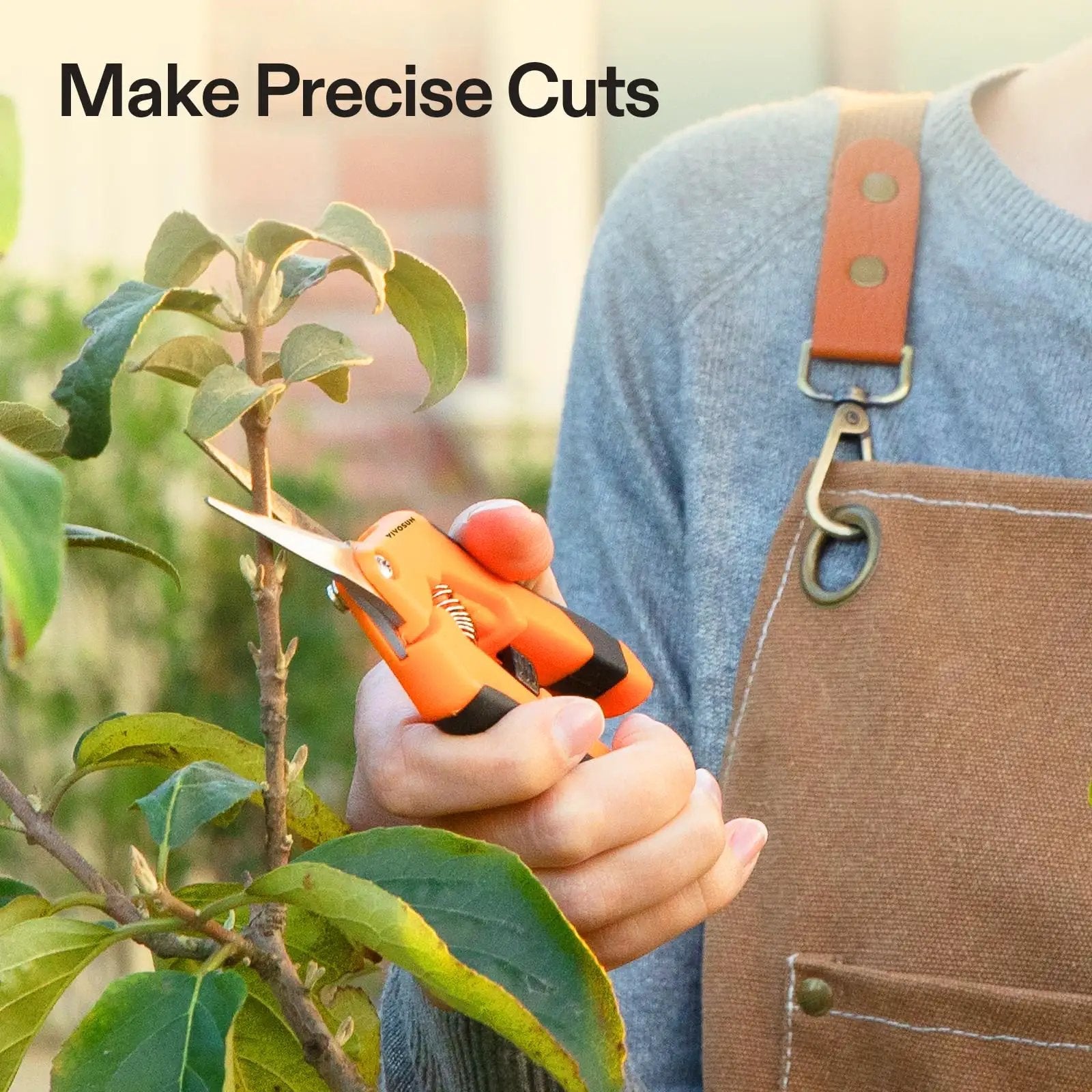 Person using 6.5 Inch Gardening Scissors Hand Pruner Pruning Shear With Straight Stainless Steel Blades Orange 1 Pack on plant