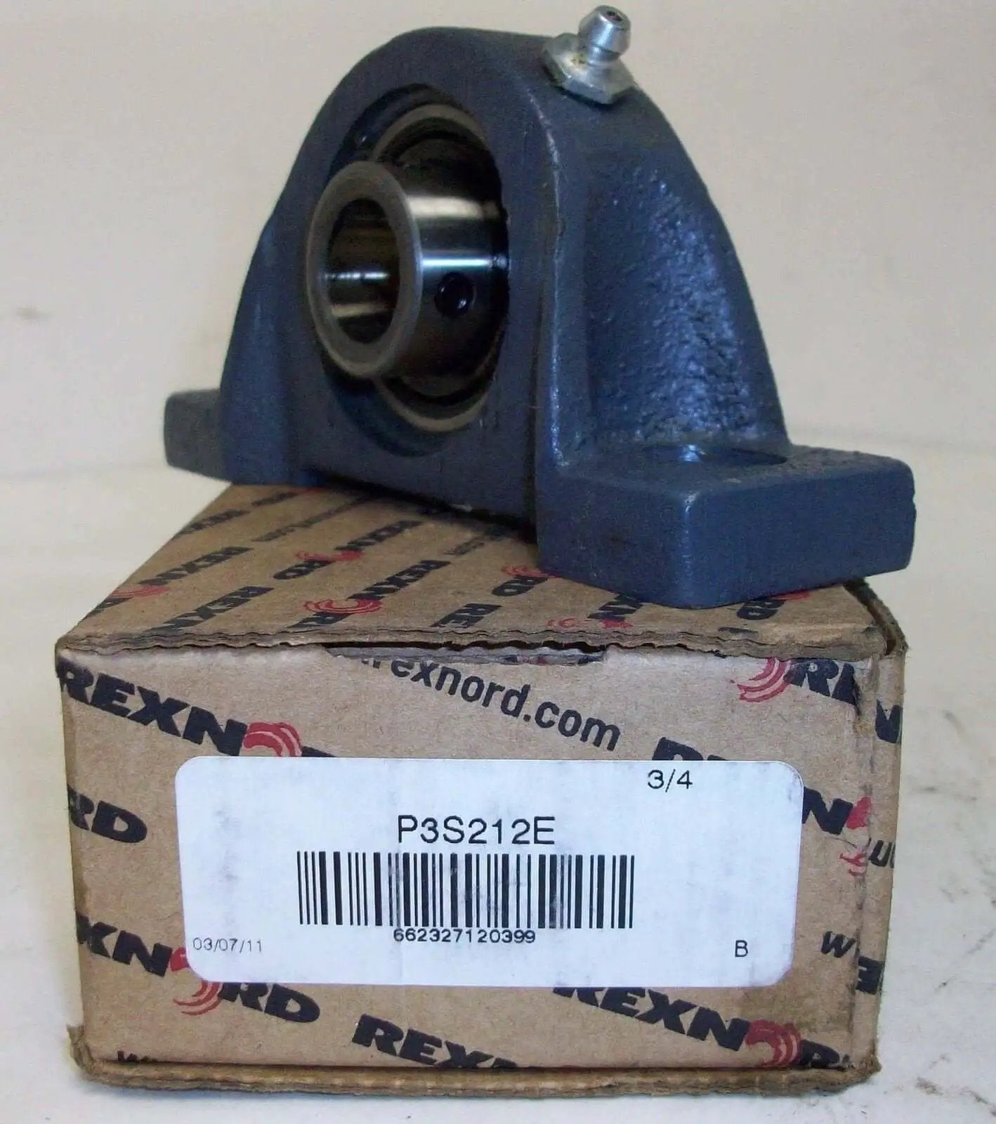 Pillow Block Bearing Housing P3S212E for Industrial Equipment and Conveyor Systems, shown with Rexnord packaging.