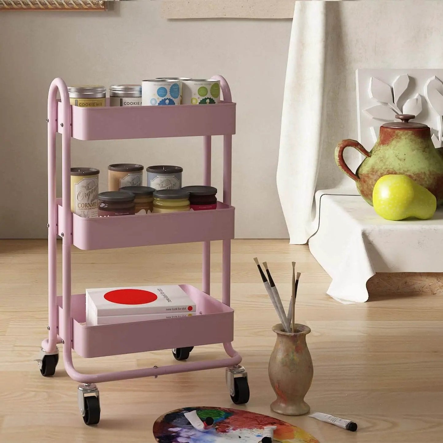 Pink 3 Tier Utility Rolling Cart On Wheels For Kitchen Office Home And Garden Elitehouse Metal Storage Cart With Locking Wheels Durable Mobile Organizer 13.4 By 18.1 By 31 Inches in a room setting with art supplies.