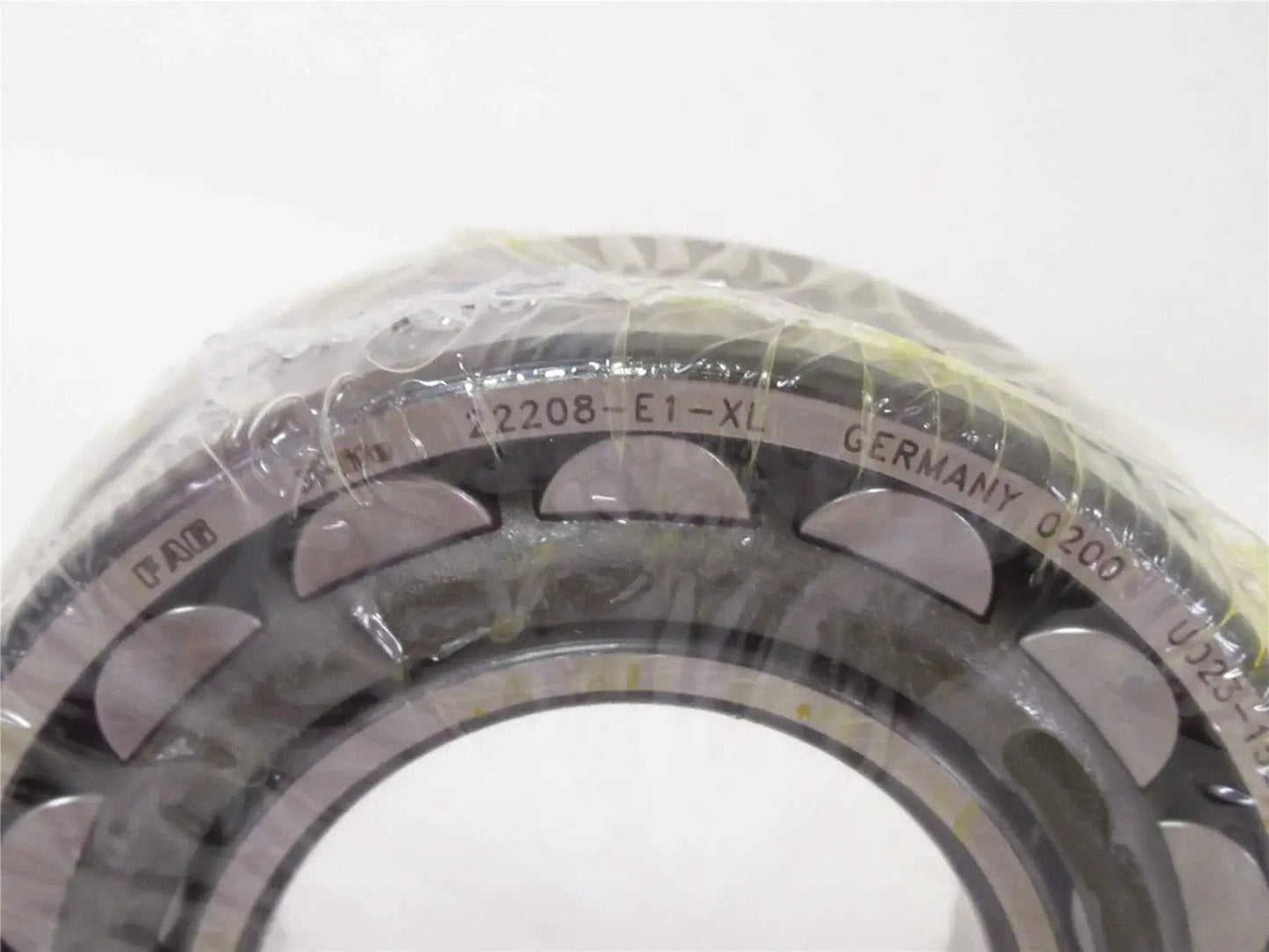 Close-up of high precision spherical roller bearing 22208 E1 XL 40x80mm with sealed design, showcasing markings and structure.
