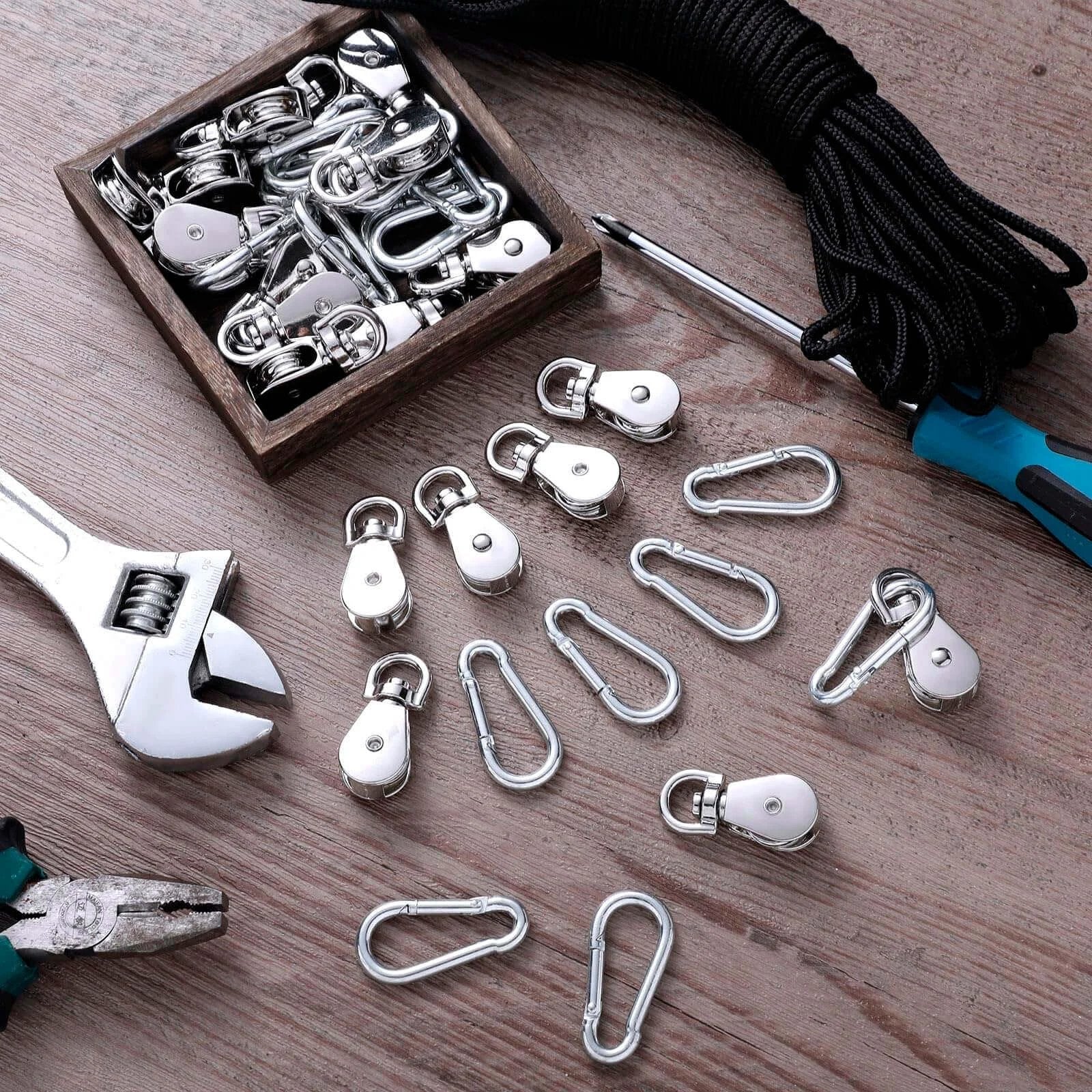Pulley Block System Set, M20 Pulley Wheel Stainless Steel with 66ft Nylon Rope and Hooks on wooden surface, tools visible