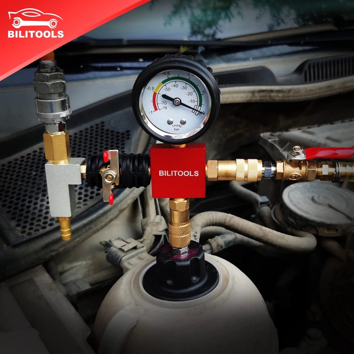 Close-up view of Radiator Coolant Pressure Tester And Vacuum Refill Kit 28 Piece Universal Cooling System Tool Set on a vehicle.