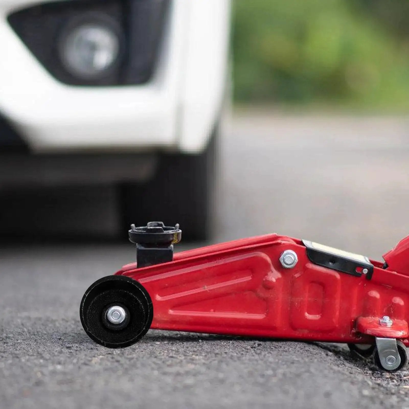Universal Steel Front Wheel Replacement for Hydraulic Floor Jacks in use, showing smooth mobility on red jack.