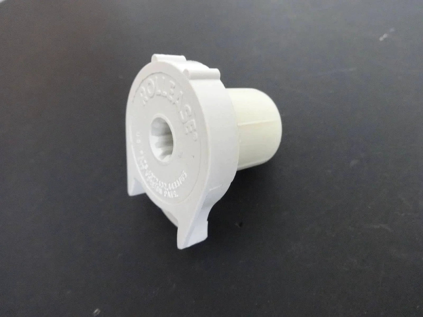 Side view of R3 Roller Shade Clutch for 1 1/8" Tube - Natural, for Roller Shades on dark background.