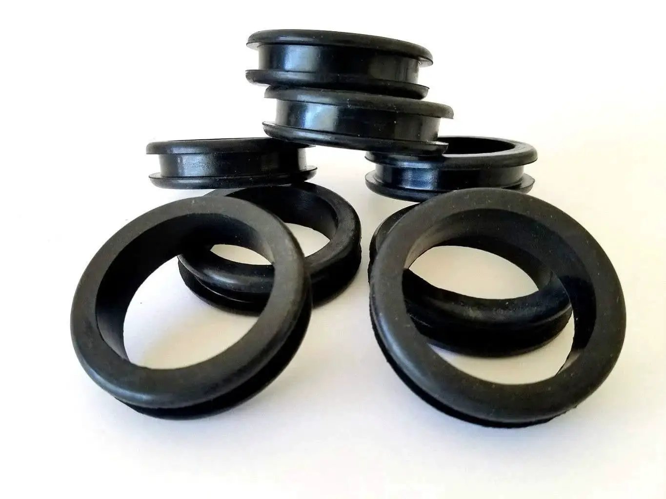 Eight-pack rubber grommets designed for 1-3/4 inch holes, featuring 1.5 inch inside diameter and 0.25 inch groove, stacked and uninstalled.