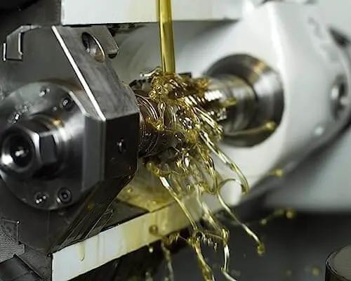 Trinity Cool XM3 Gates Engineered Lubricants Pro Grade High Performance Semi Synthetic Metalworking Fluid in use, close-up view.