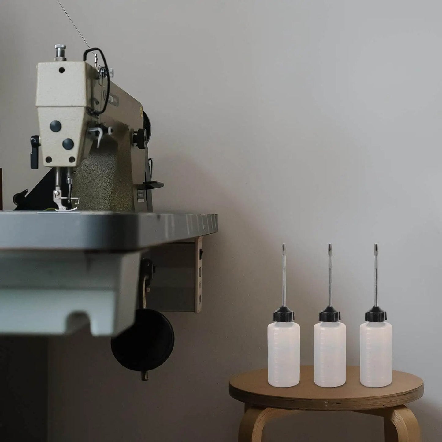 Long Mouth Nozzle Oil Bottles For Sewing Machines And Home Tools Three Pack Plastic Oiler Pots on table near sewing machine