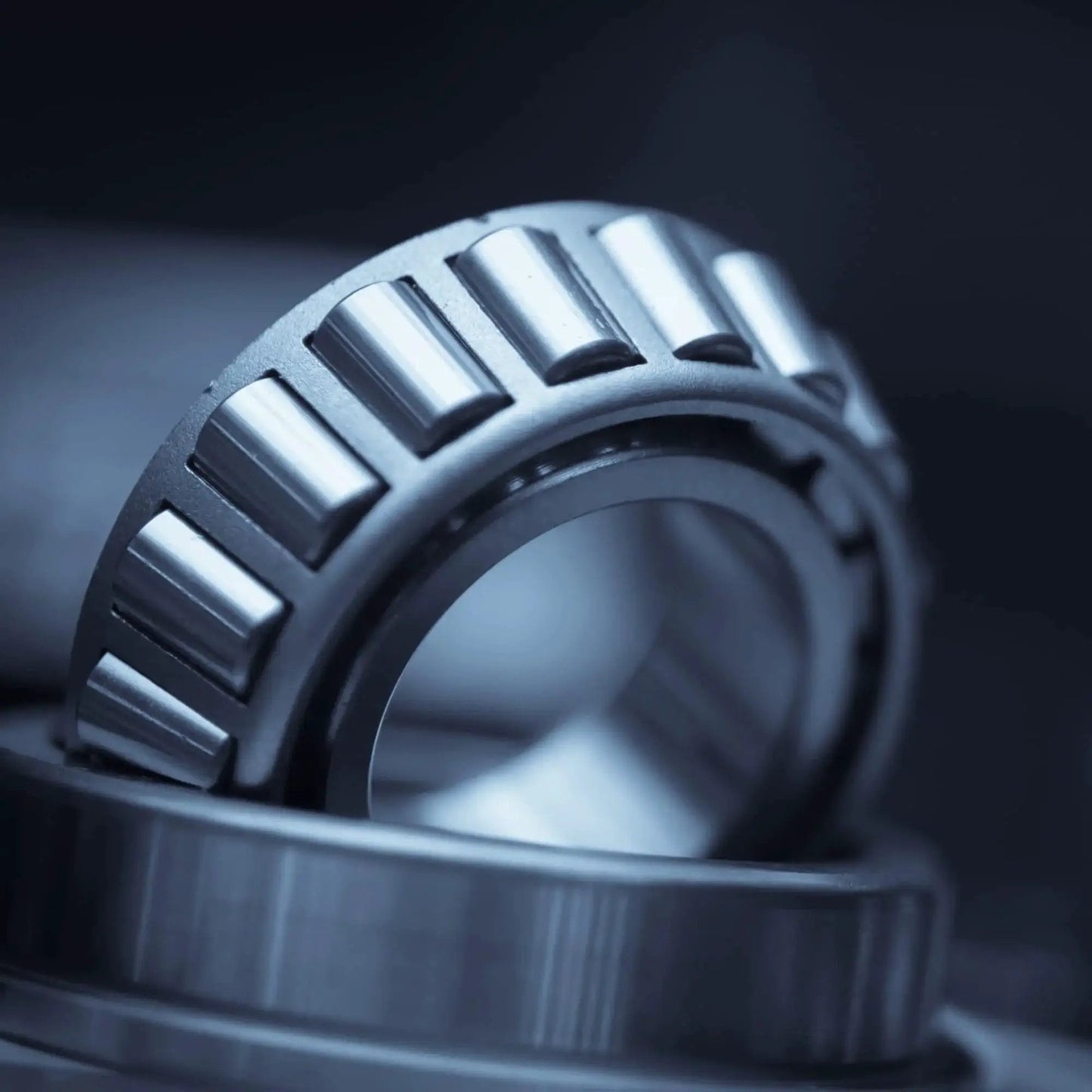 Close-up of Single Row Tapered Roller Bearing Cone and Cup Set for axial and radial load support in machinery.