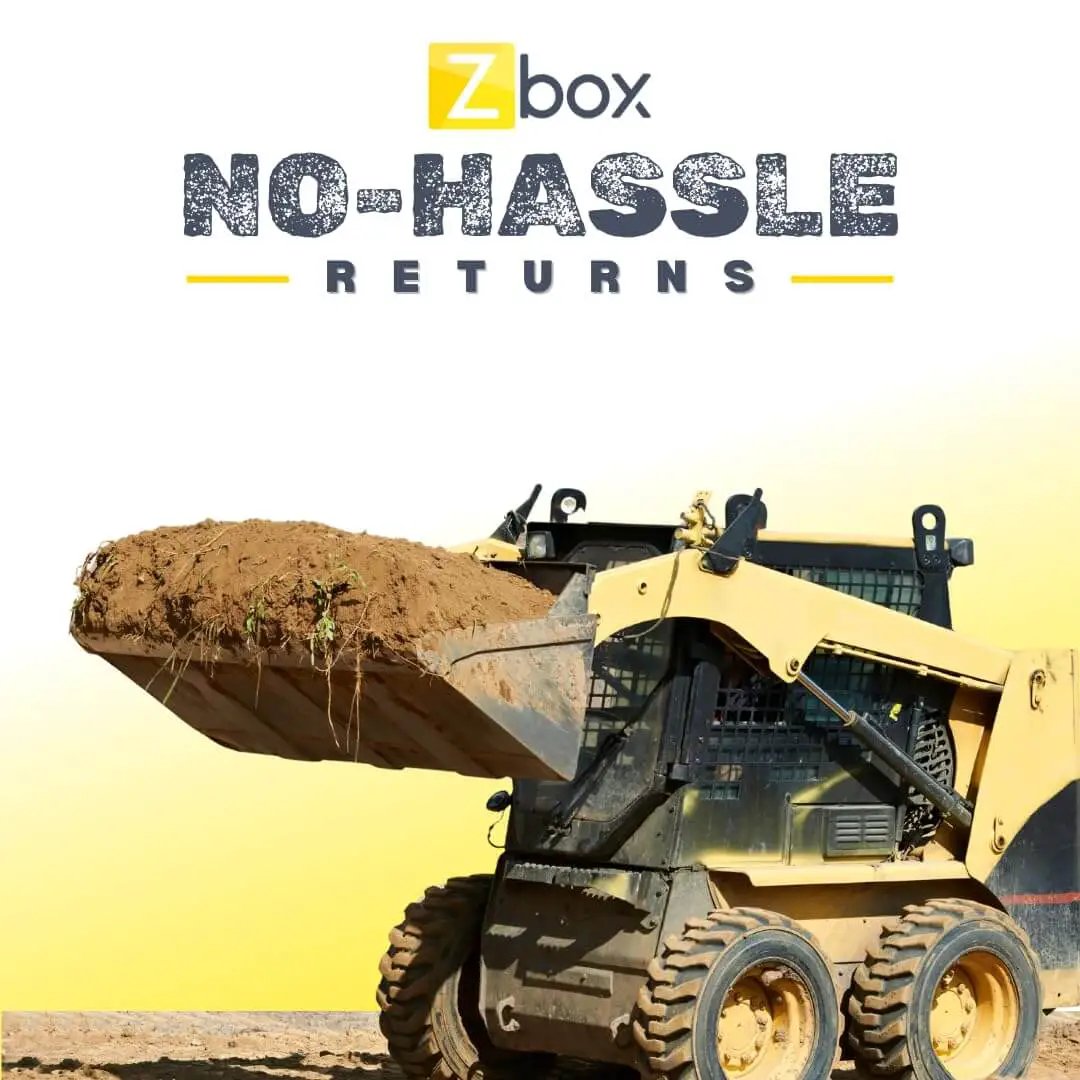 Front view of a skid steer loader lifting a bucket of soil, promoting Zbox no-hassle returns policy.