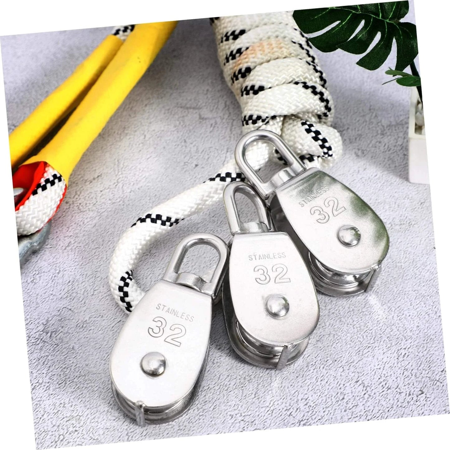 3pcs Heavy Duty Stainless Pulley Swivel Lifting Wire Rope Crane for Construction DIY Projects on a textured surface